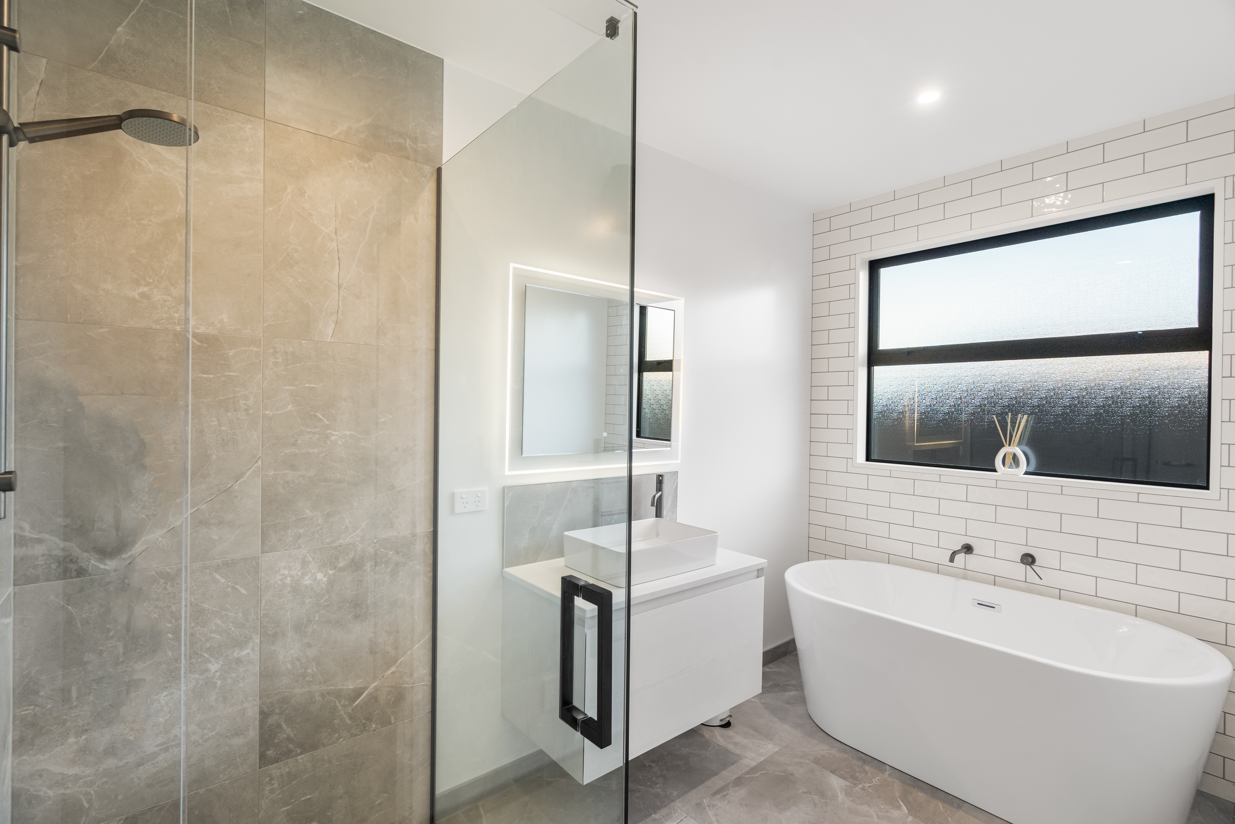 Modern bathroom, showcasing wall to wall tiling, freestanding bath by Senna Developments, Lincoln, Canterbury