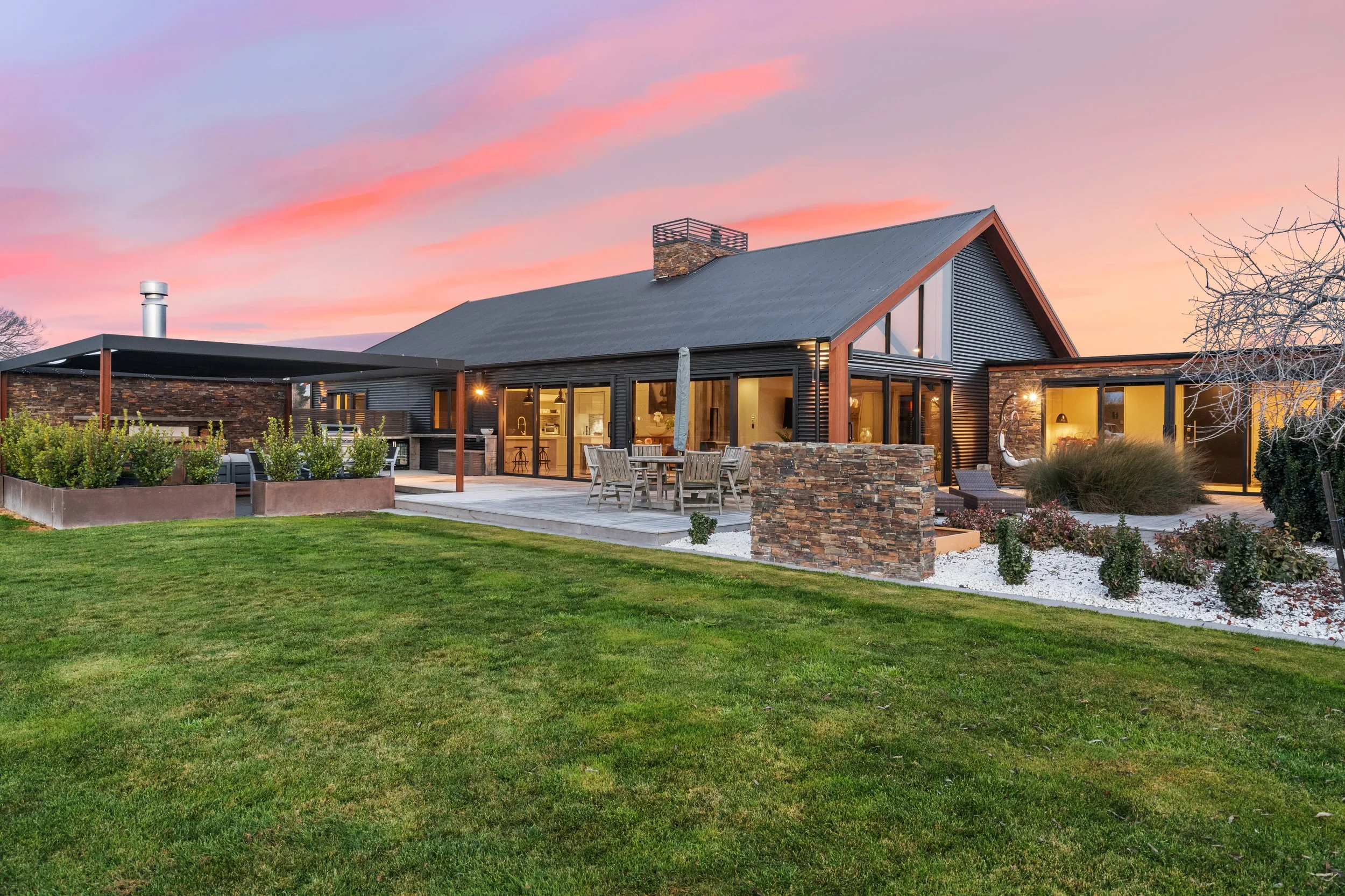 A 370 sqm home barn style home, built by Senna Developments, featuring schist stonework, black Metalcraft corrugated iron to emphasis the barn, located in Lincoln, Selwyn, Canterbury.