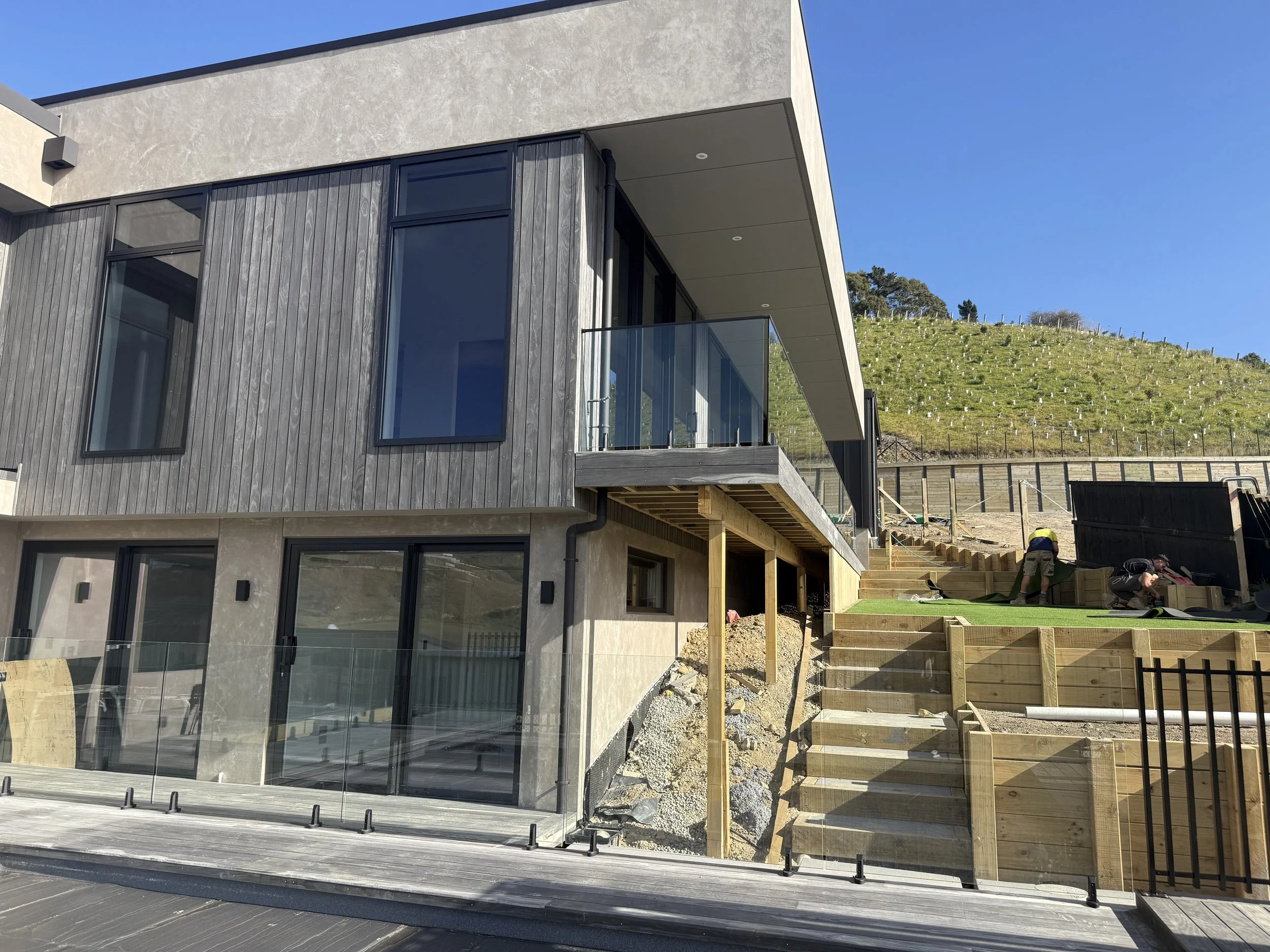 Tiered timber retaining walls, steps and landscaping in the Cashmere Hills, Christchurch by Senna Homes.