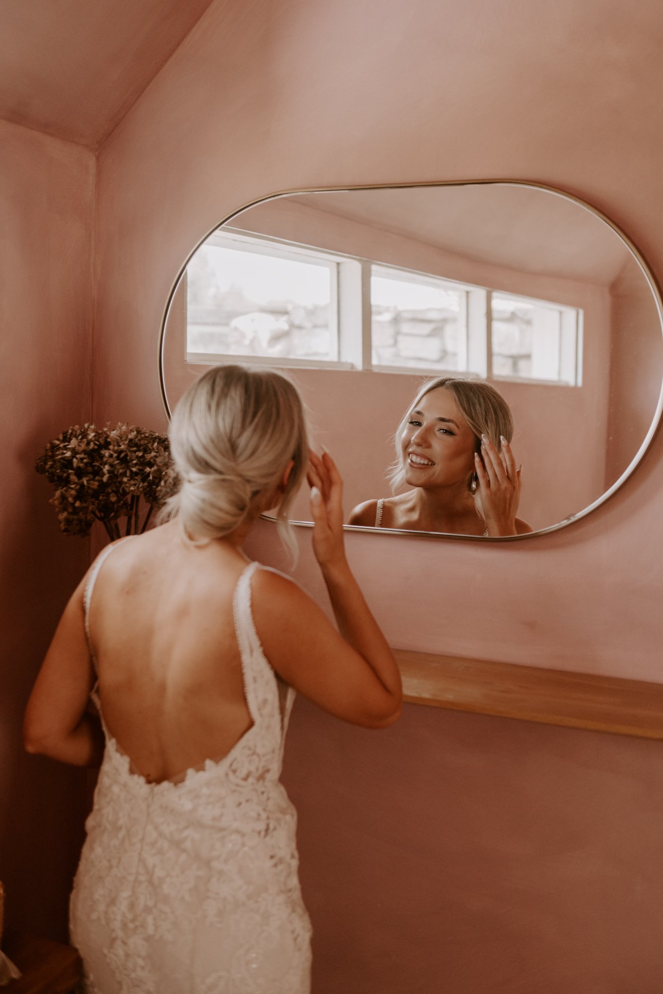 A relaxed bride getting ready for her wedding day in the pink bathroom at Shepherds Story in Ross Tasmania
