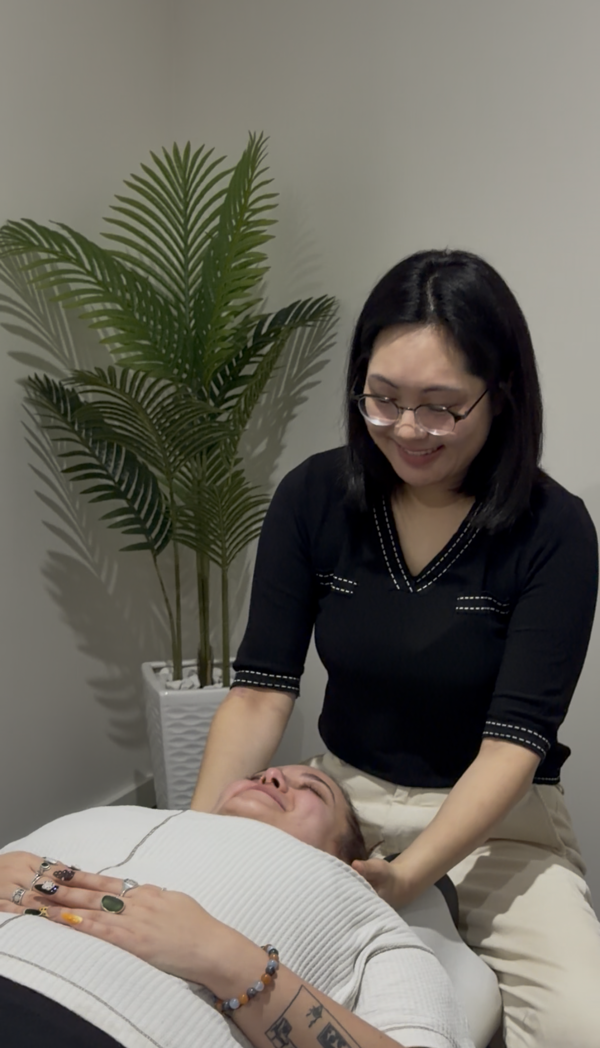 Dr Mia Ghil treating a patient lying on the chiropractic table