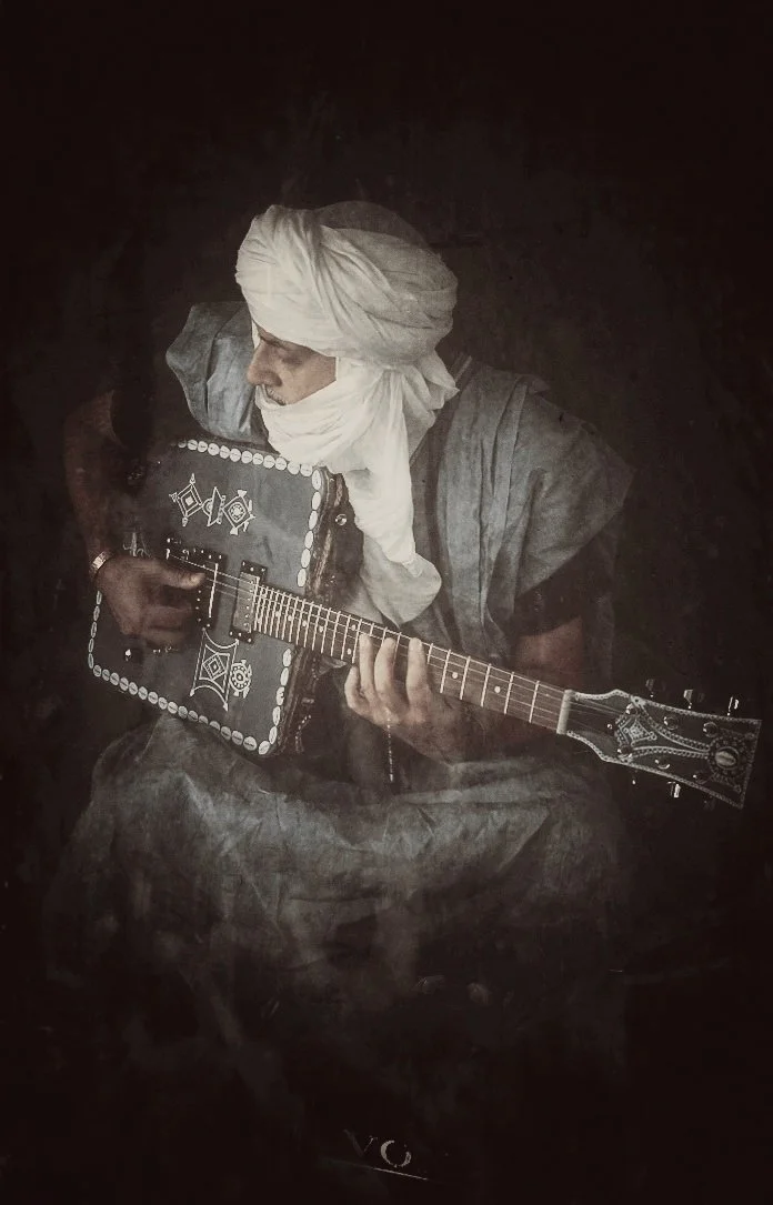 Gembara — portrait with the electric string instrument.