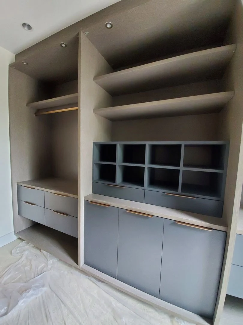 Modern wardrobe with open shelves, closed cabinets, and drawer space