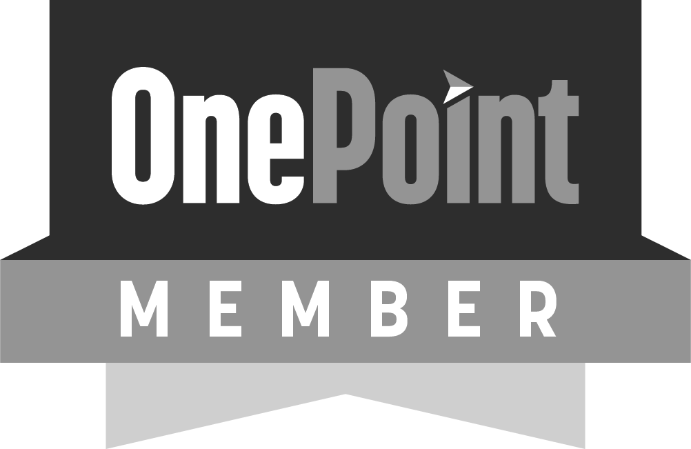 A grayscale badge with the text 'OnePoint MEMBER', with 'OnePoint' on top in larger font and a directional arrow in the letter 'i', and 'MEMBER' below in smaller font within a shield shape.