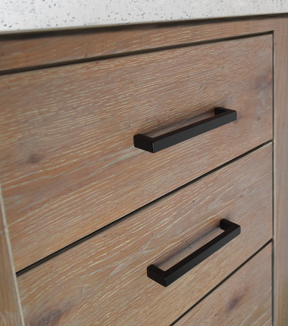 Close-up of wooden cabinet drawers with black handles