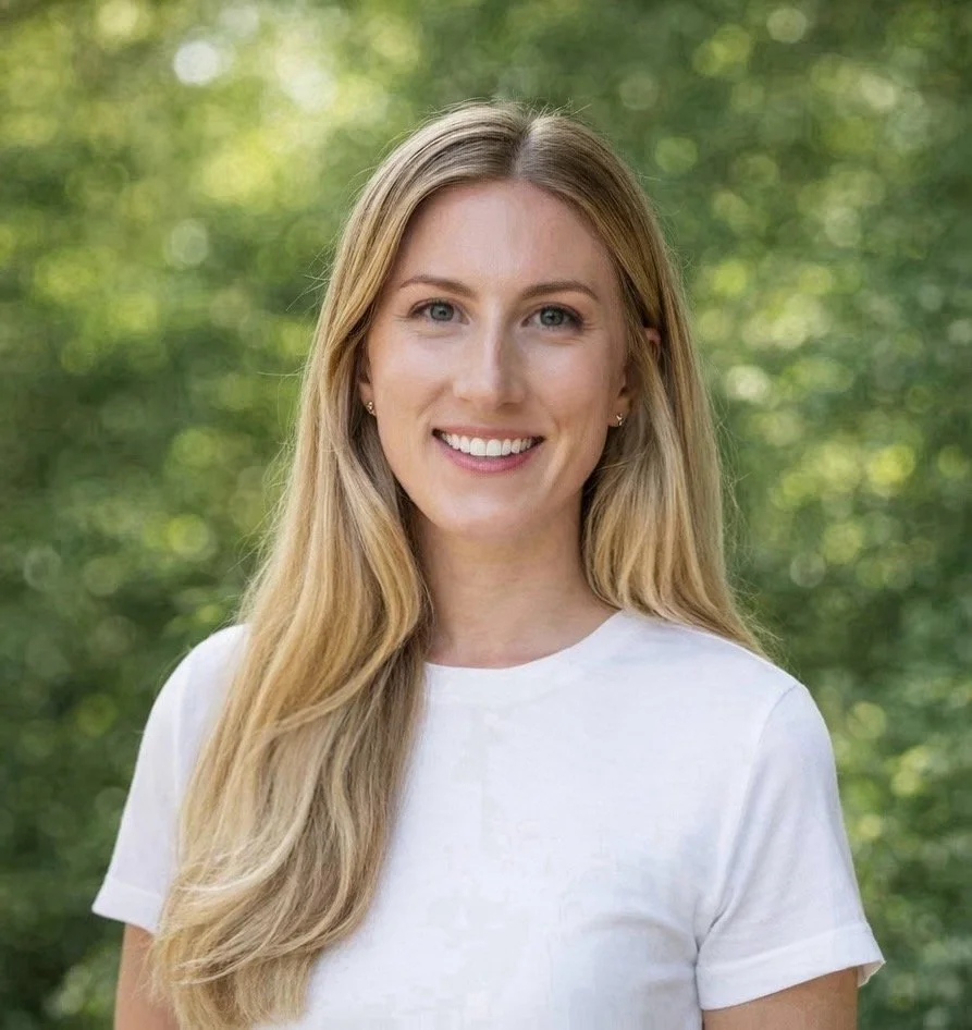 Headshot of Taylor Addison outdoors with a natural green background