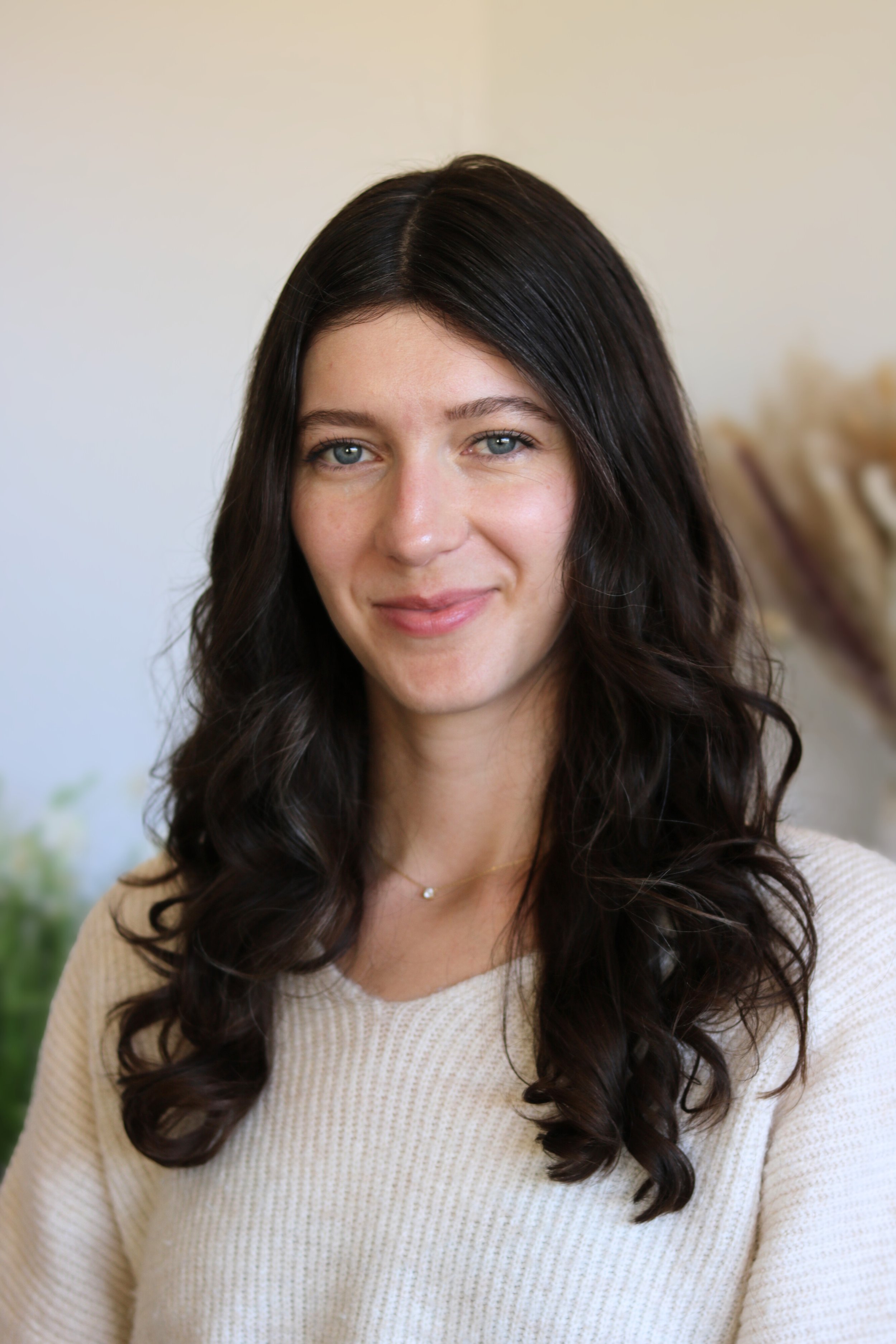 Professional headshot of Emily Feldt Shabel in a bright indoor setting