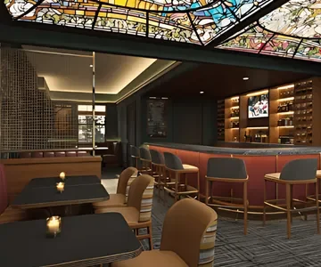Interior of a modern bar or lounge with a curved bar counter, barstools, and a TV screen on the wall.