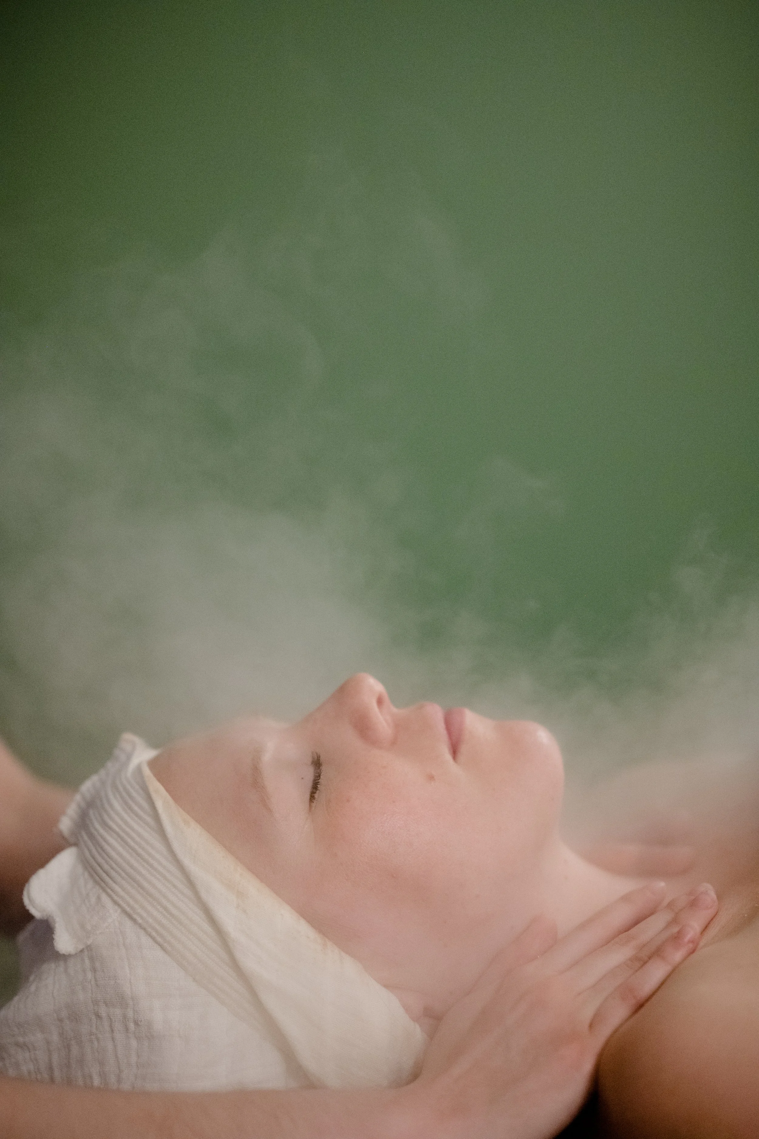 Woman giving facial massage to man