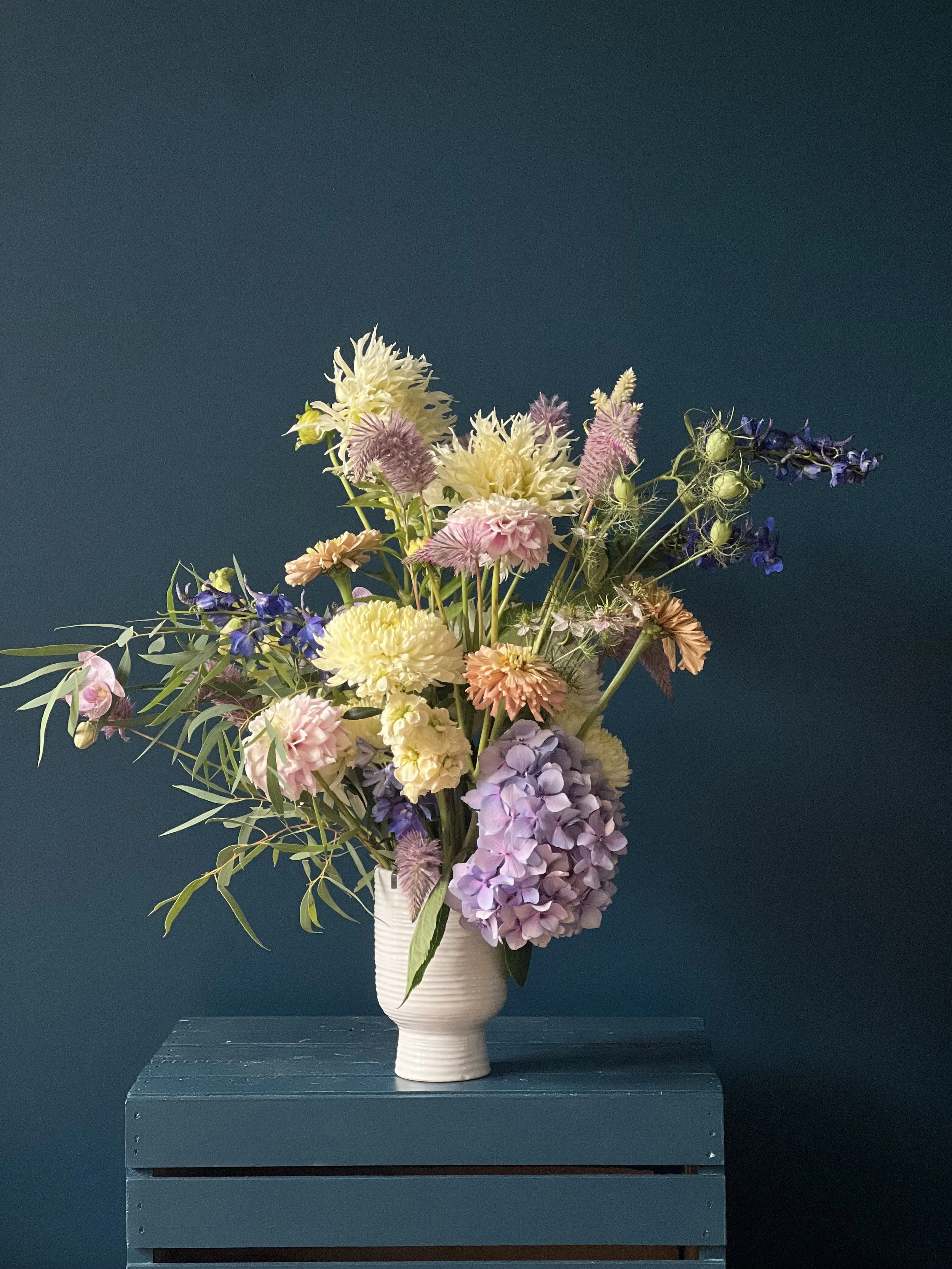 Condolence flowers designed in a vase with mums, hydrangea, zinnia and dahlia in muted colors, as a sympathy gift designed for Portland flower delivery by Portmanteau Flower Co