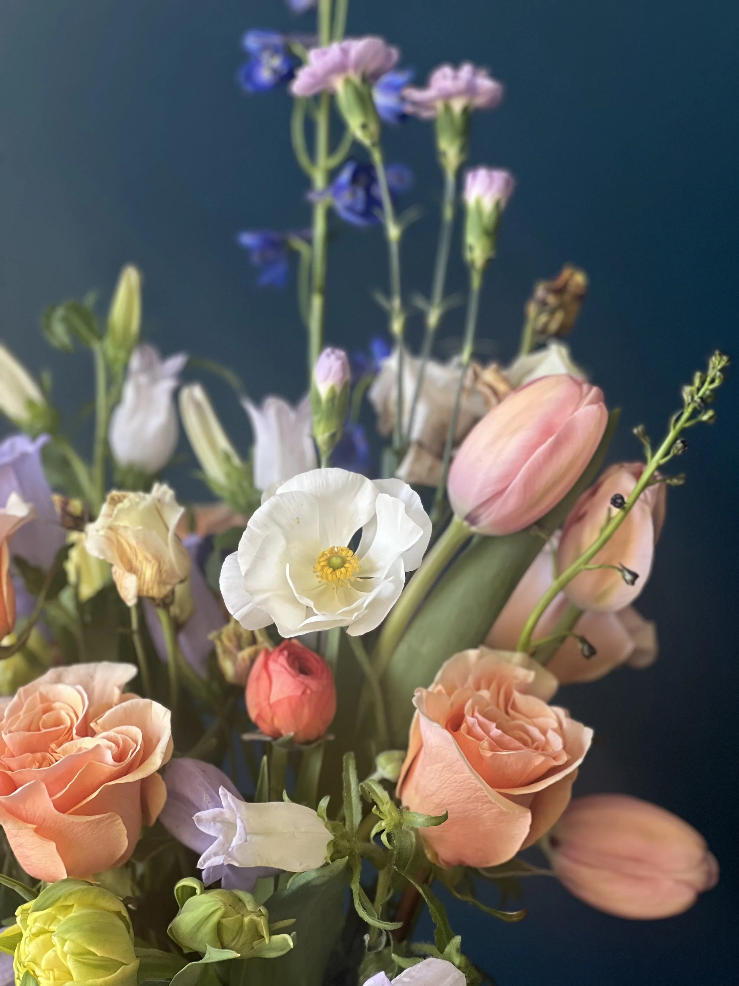 mothers day flowers in spring blooms with white anemone, orange tulips and roses, made for Portland flower delivery