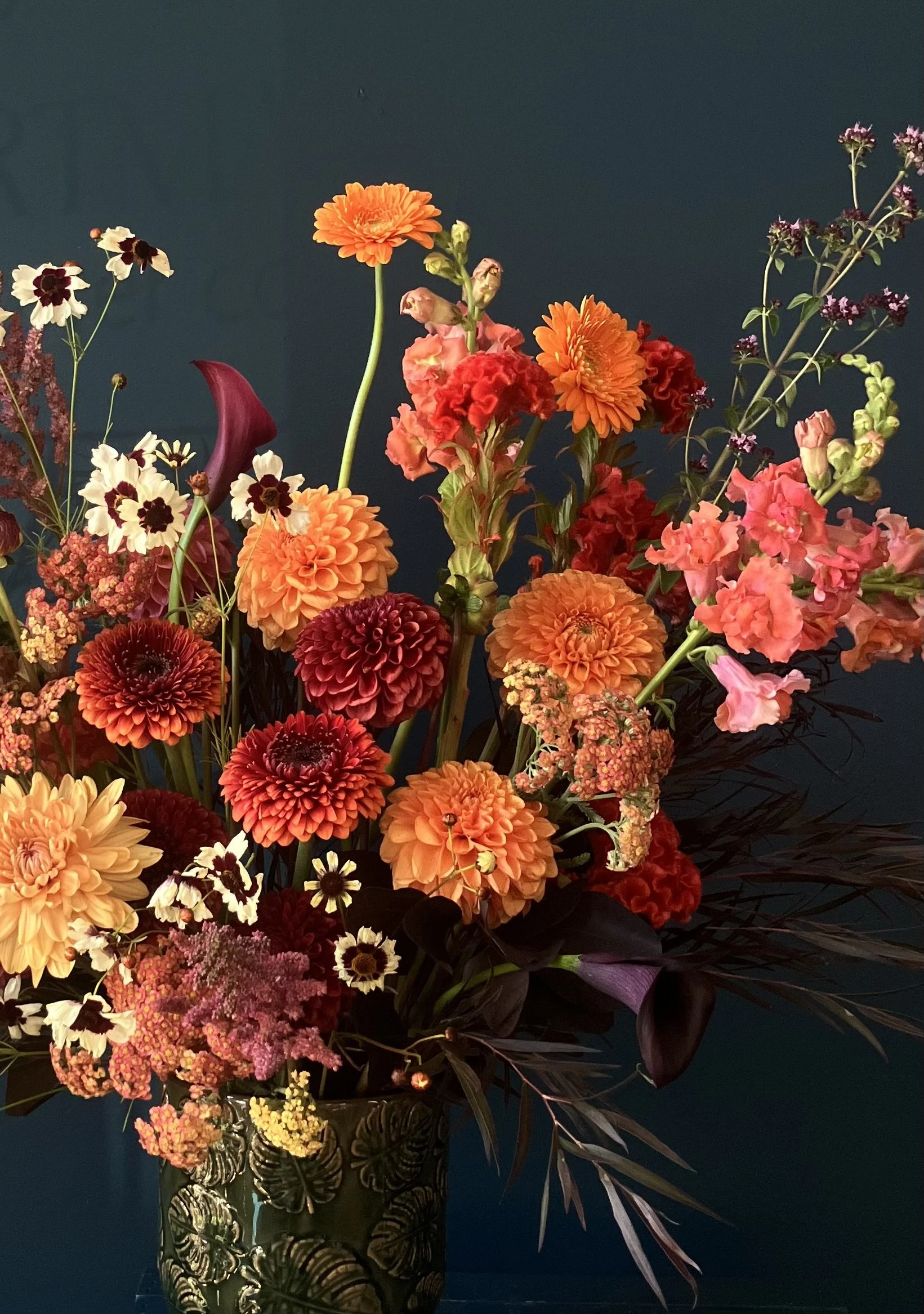 Dahlias and daisies with supporting flowers, creating a sunset color palette for an arrangement in Portland