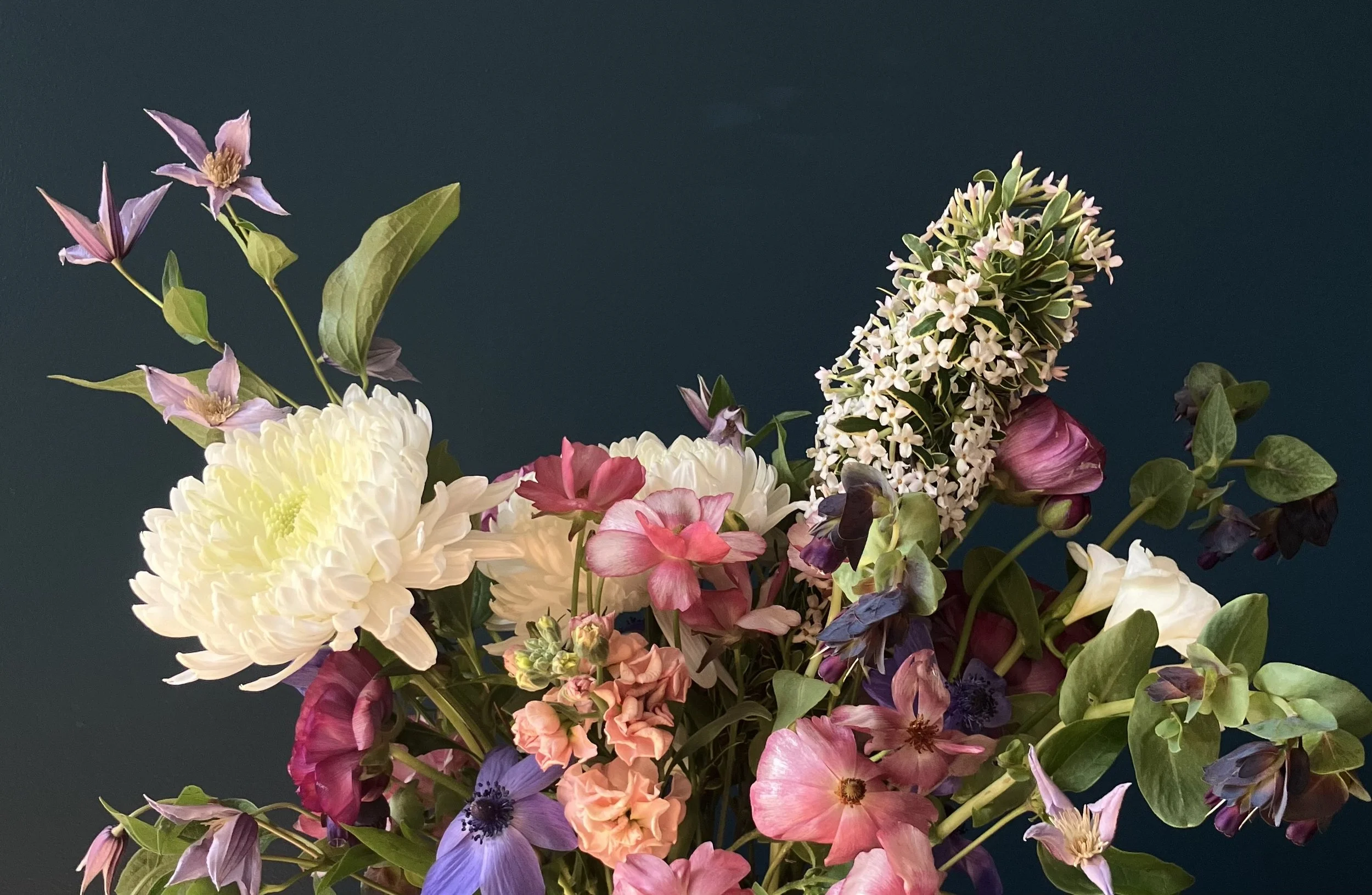 Seasonal spring bouquet with anemone, ranunculus, and freesia in soft purple and pink tones in Portland Oregon, made for Beaumont-Wilshire area