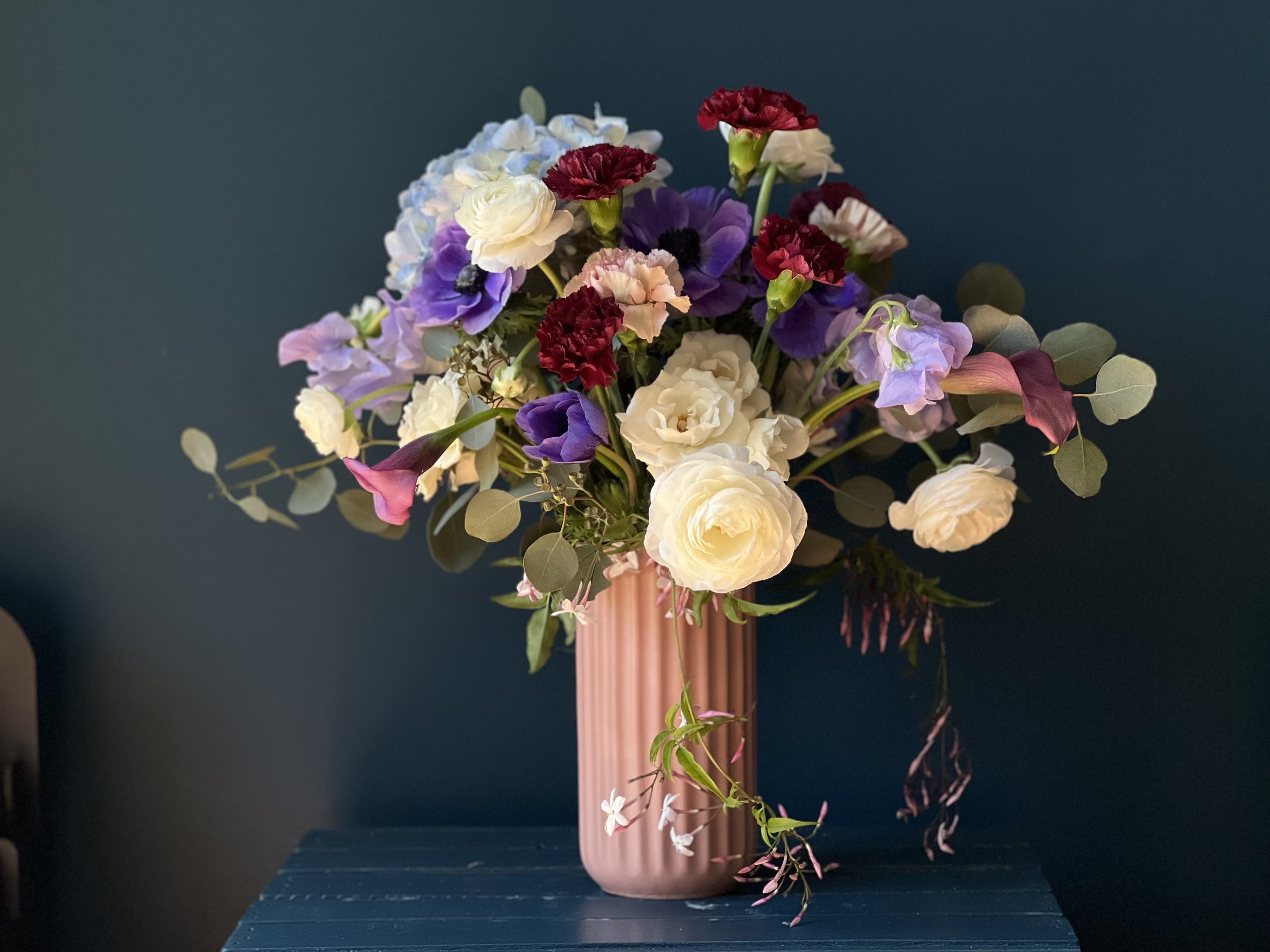 Another view of this rose, ranunculus, carnation & anemone heavy arrangement for giving in a vase to mom