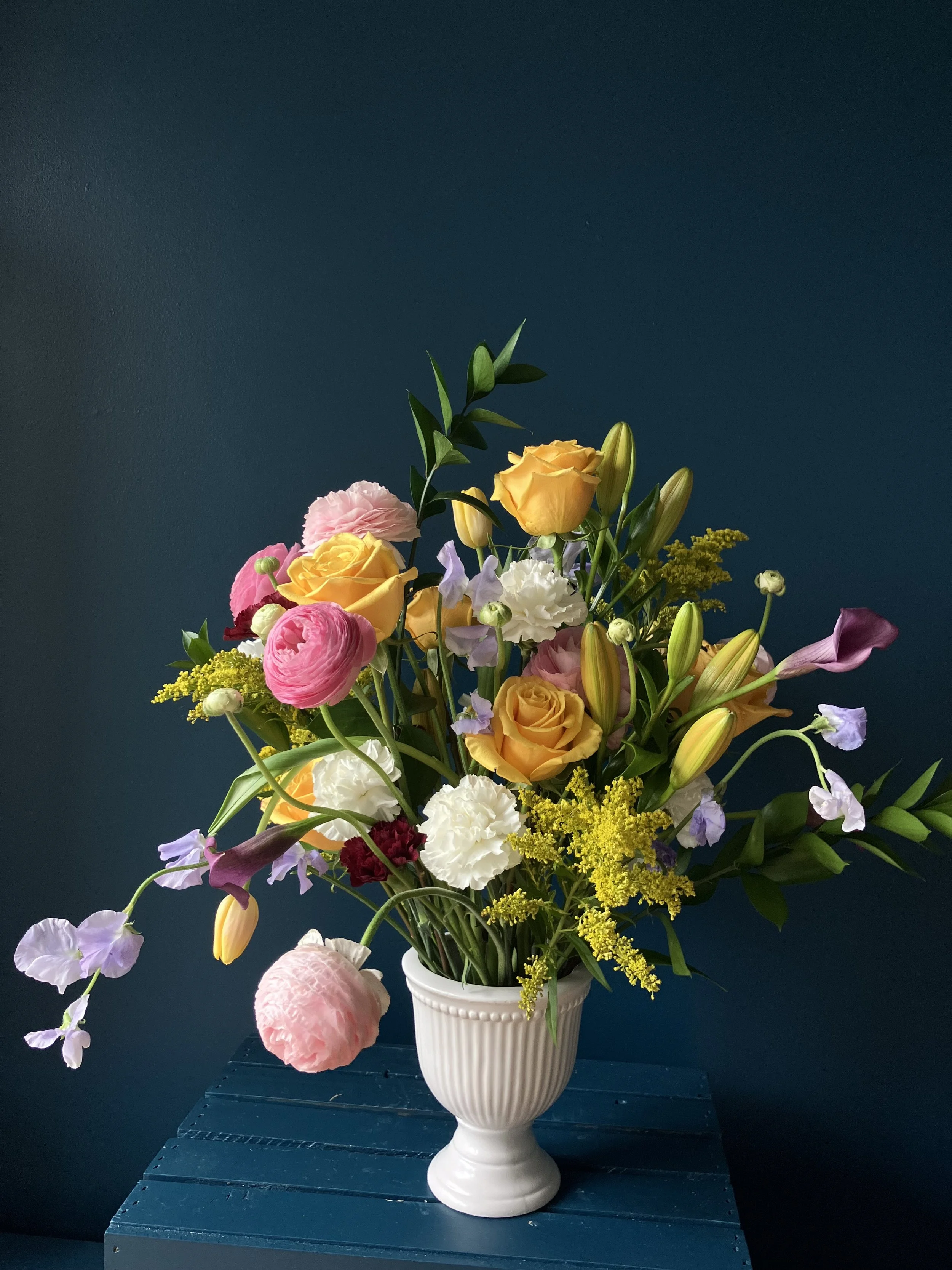 Portland florist Mother's Day arrangement with yellow roses, tulips, lilies, pink ranunculus, and sweet peas