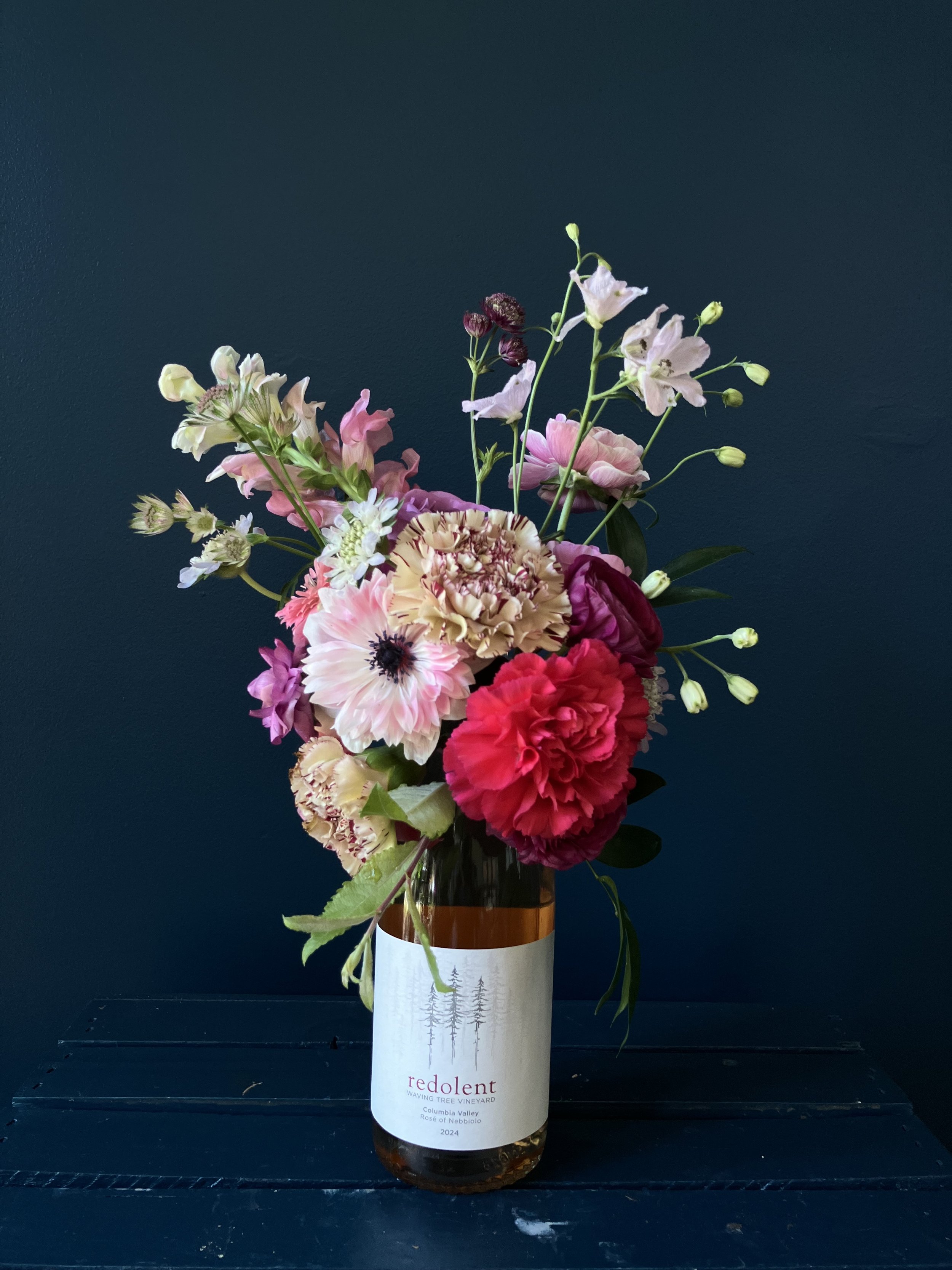 A feminine pink-white corsage designed for a graduation and made of many flower types