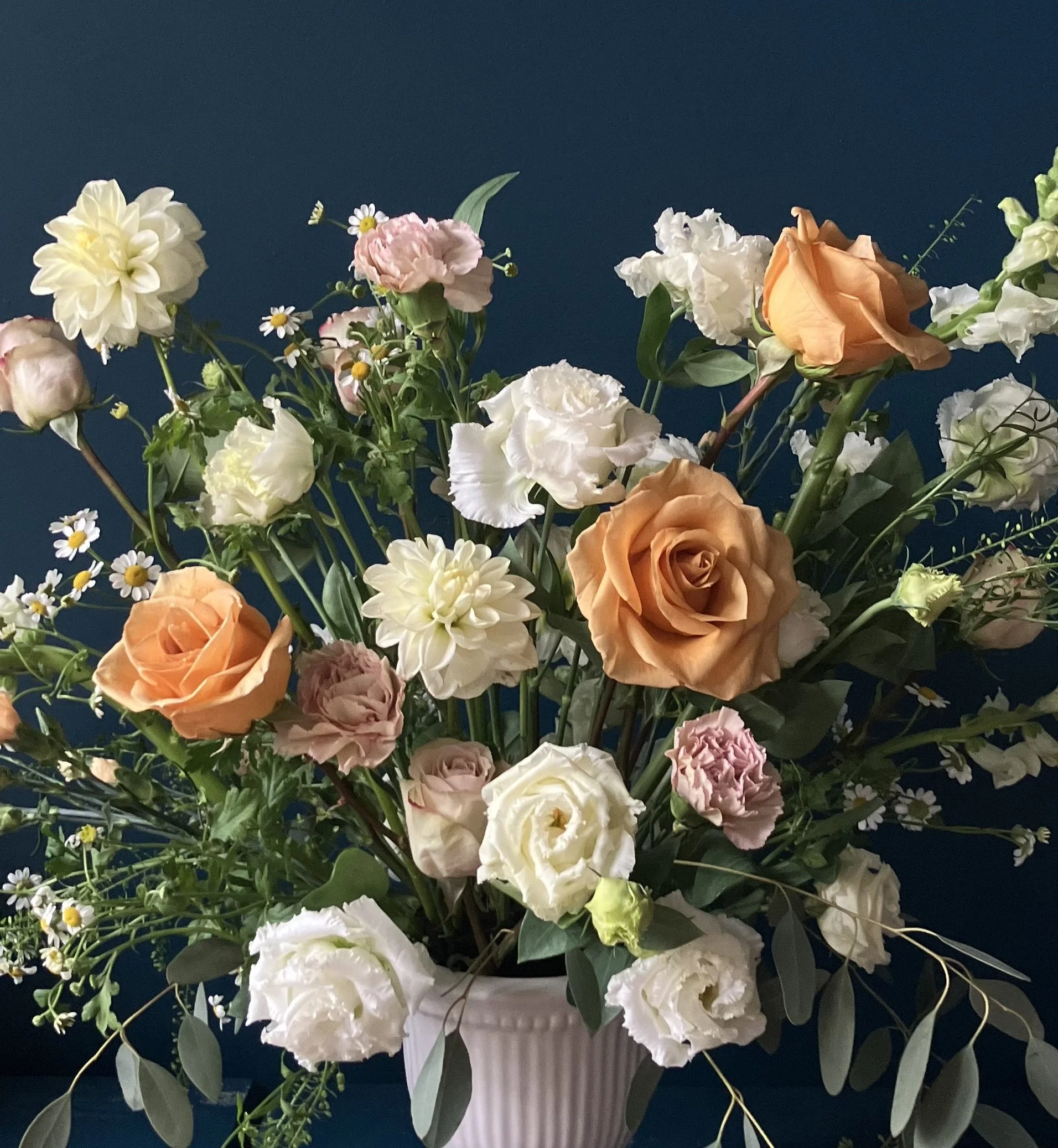 Sympathy flowers designed in Portland with a close up angle of copper roses and white lisianthus