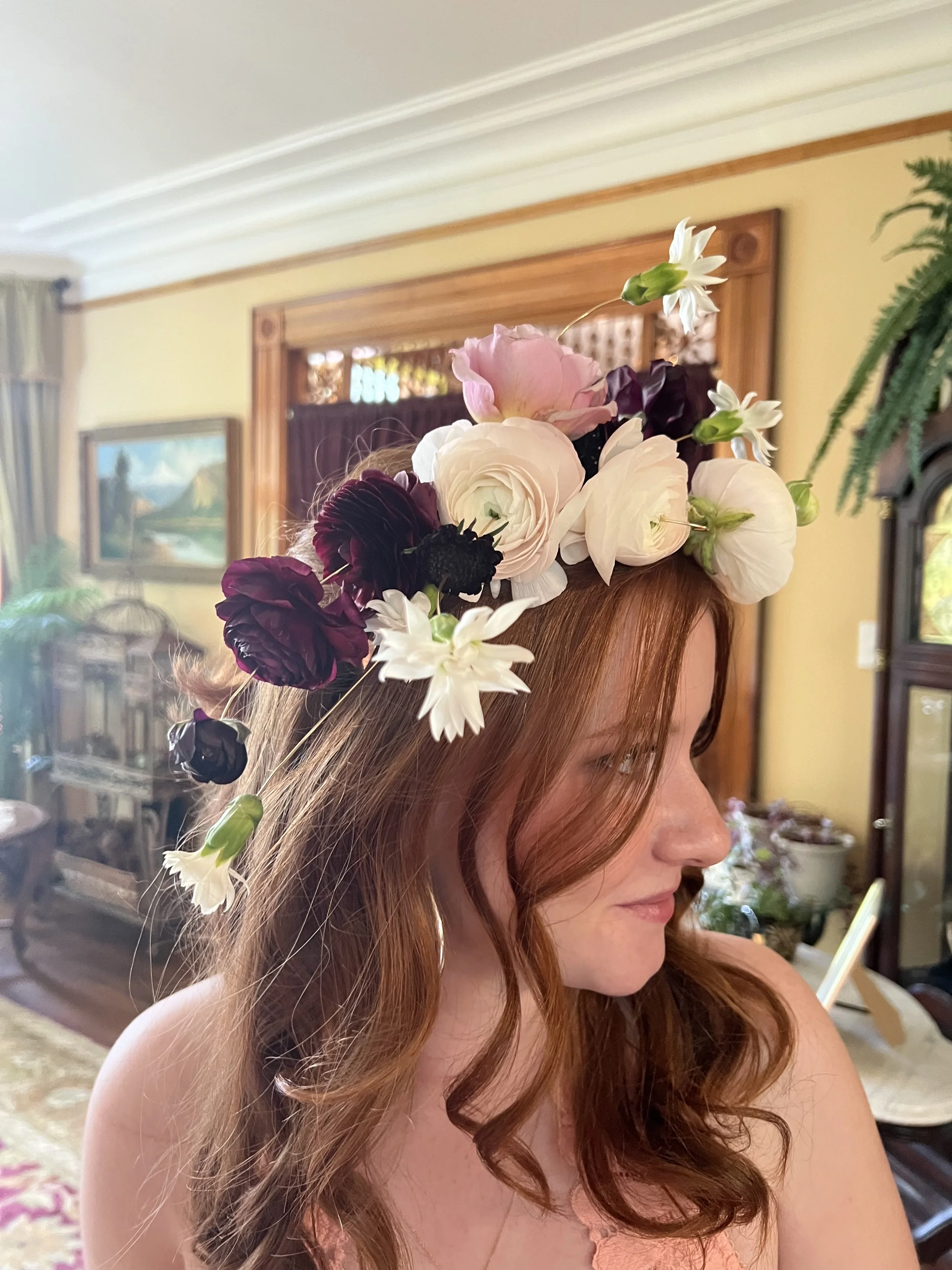 A wired floral crown on a flower girl's head, designed on a headband to wear at Portland weddings and events