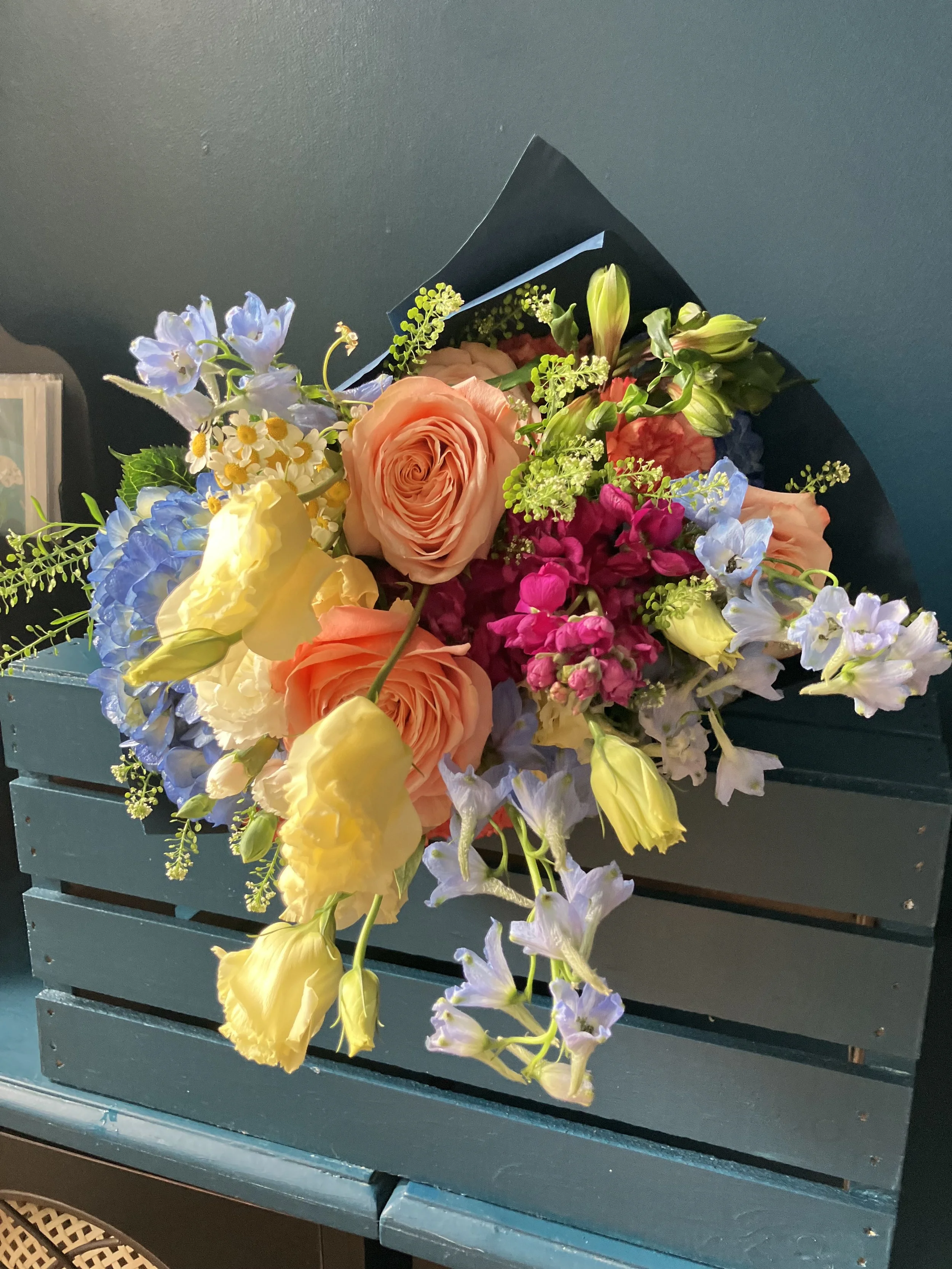 Fresh rose, lisianthus, and Cambridge bells bouquet wrapped in paper, designed by a Portland florist for delivery or pickup