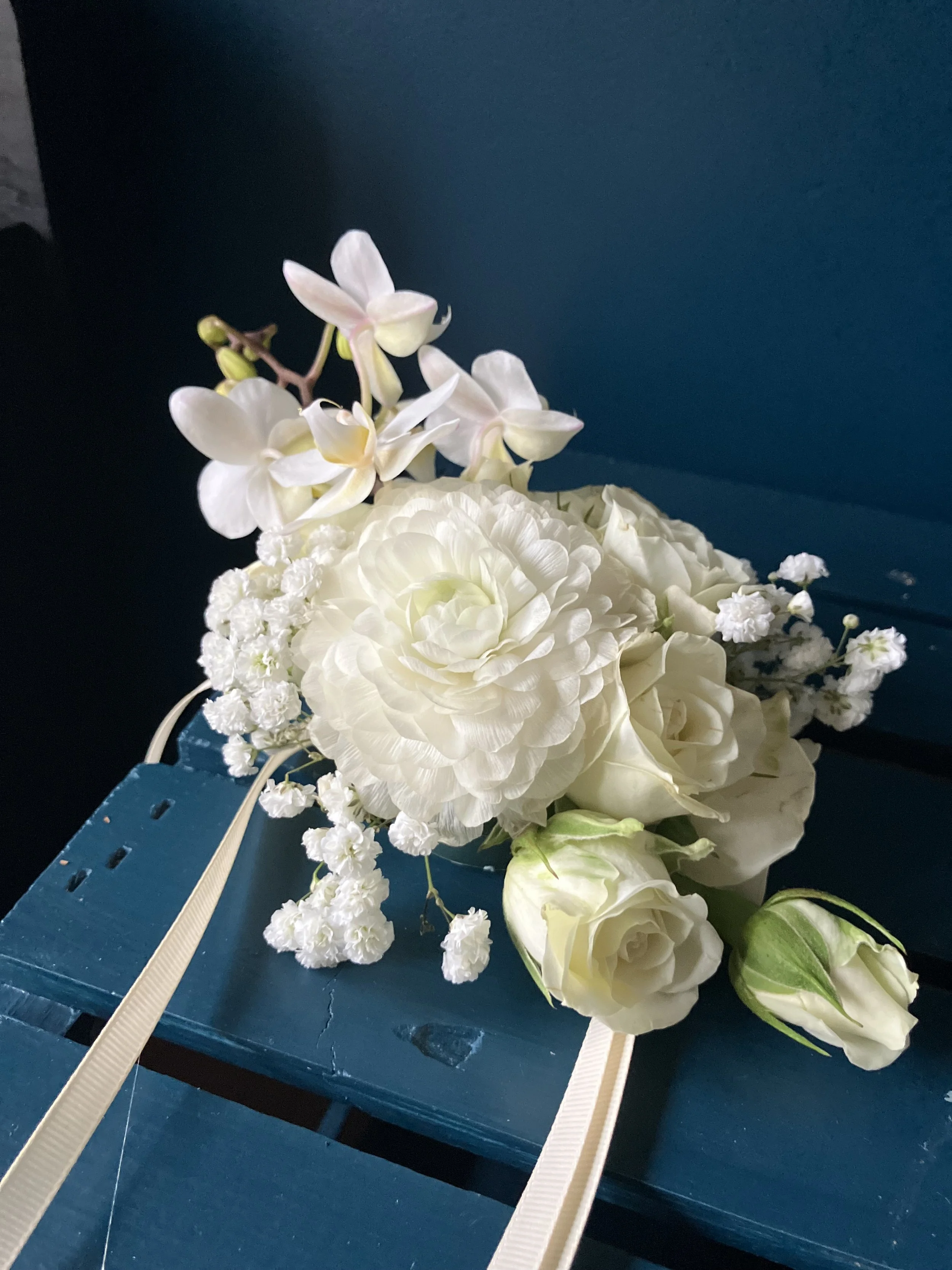 A white rose corsage with orchids & baby's breath made for a Portland, Oregon wedding