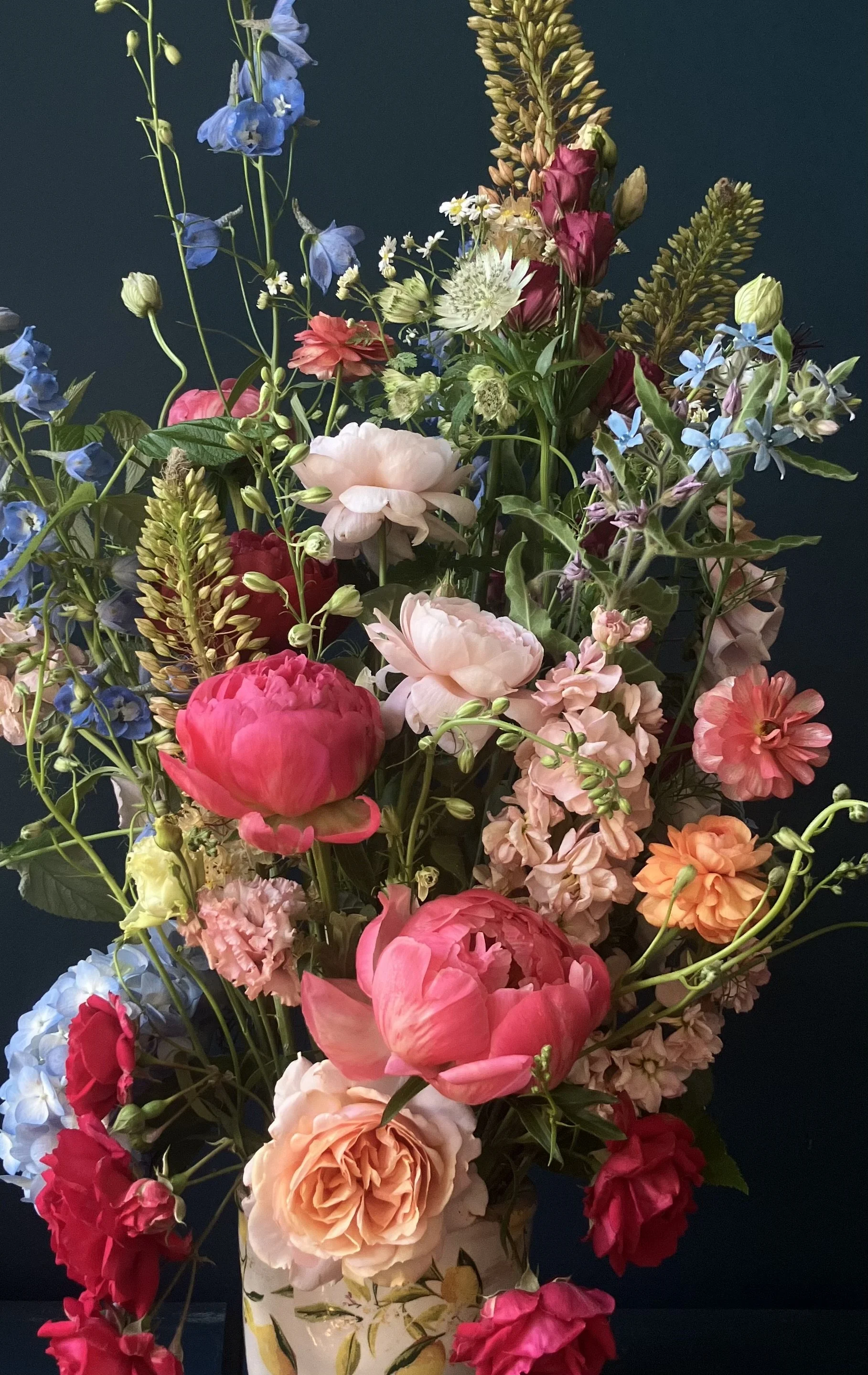 Peonies and garden roses in peach, coral and burgundy arranged in garden-style as Portland event flowers