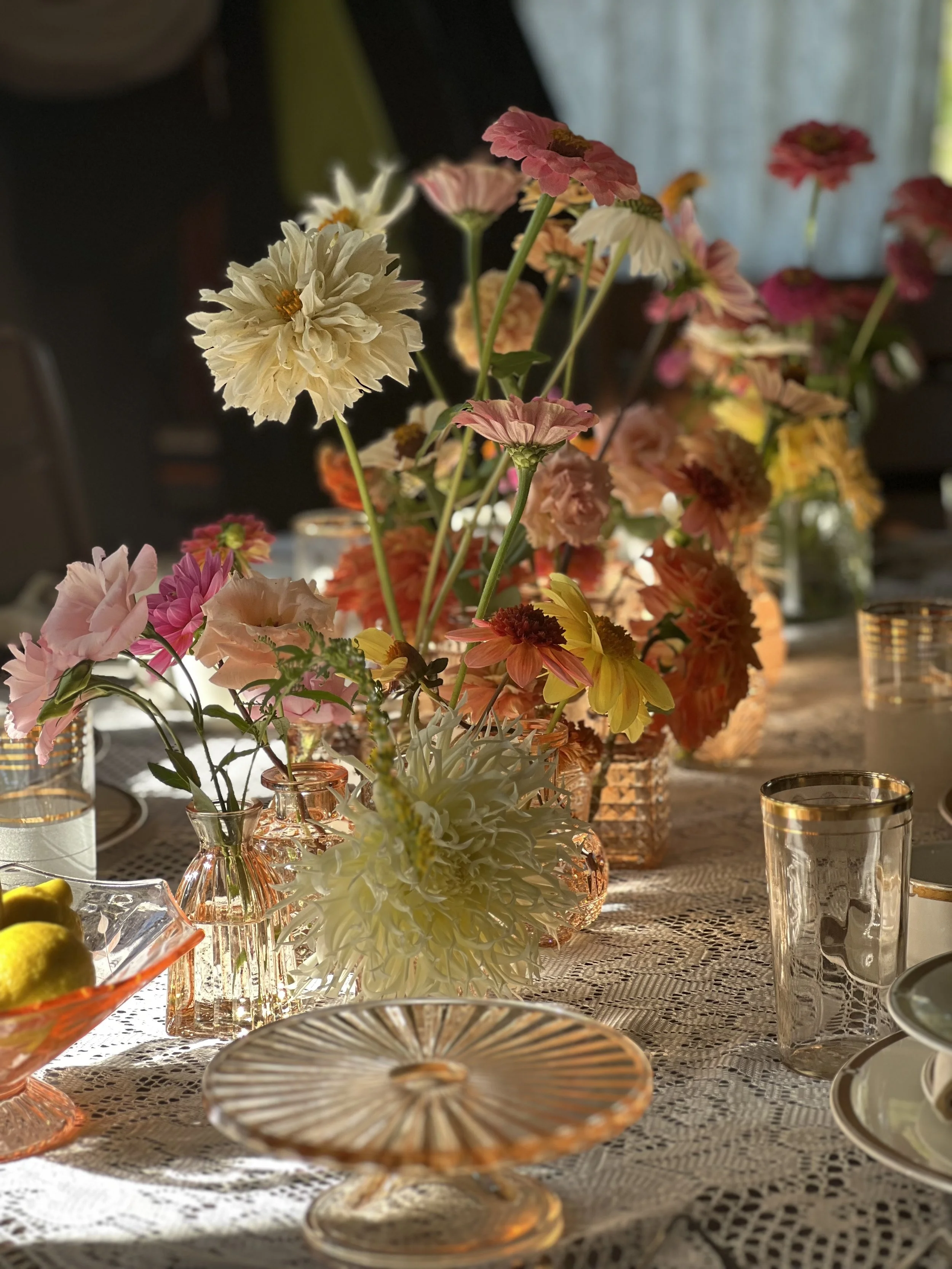 Elegant wedding centerpiece for table with pastel zinnias, dahlias, and candles, designed in Portland