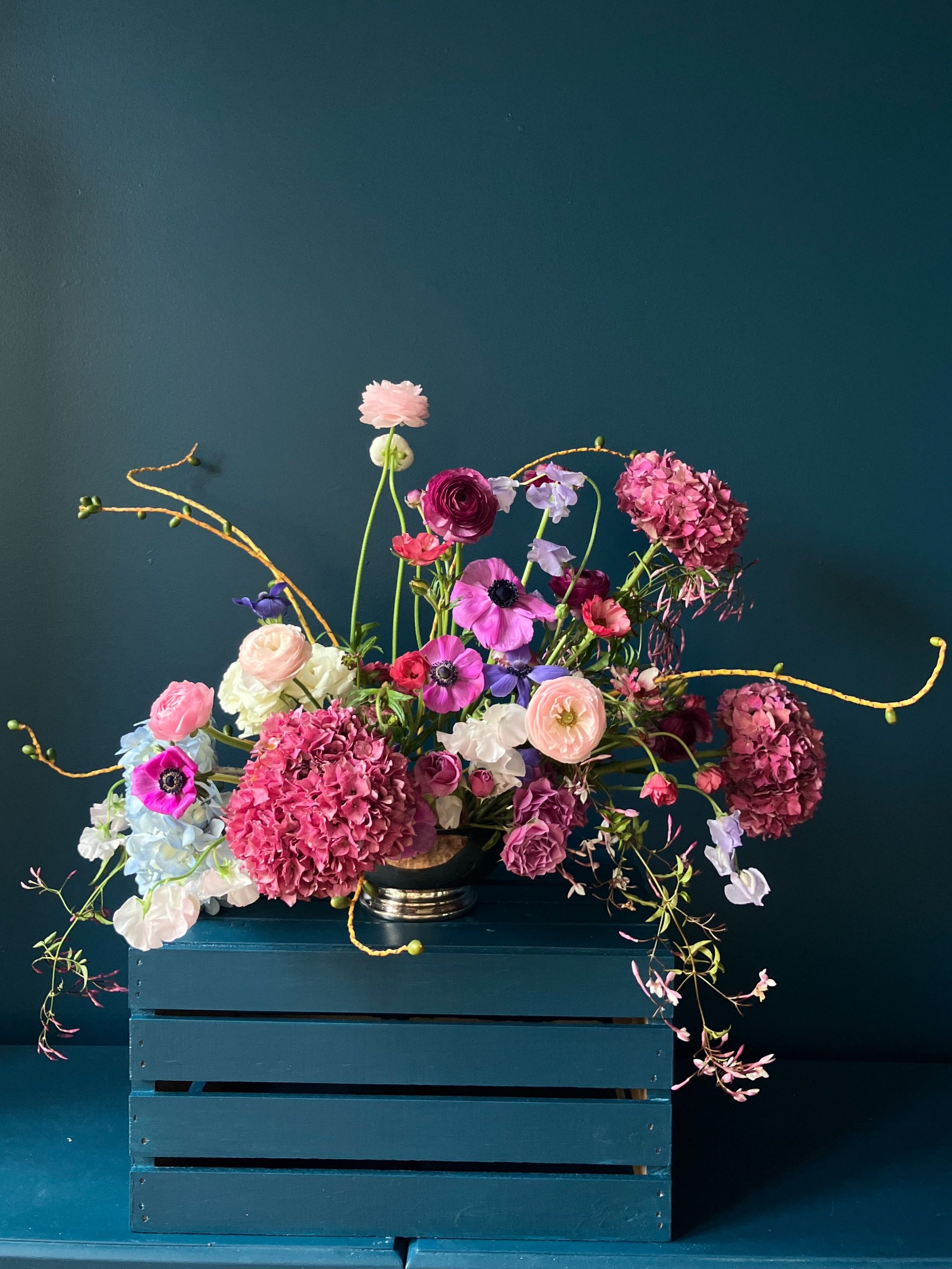 A stunning springtime bowl overflowing with scented hydrangeas, ranunculus and anemone