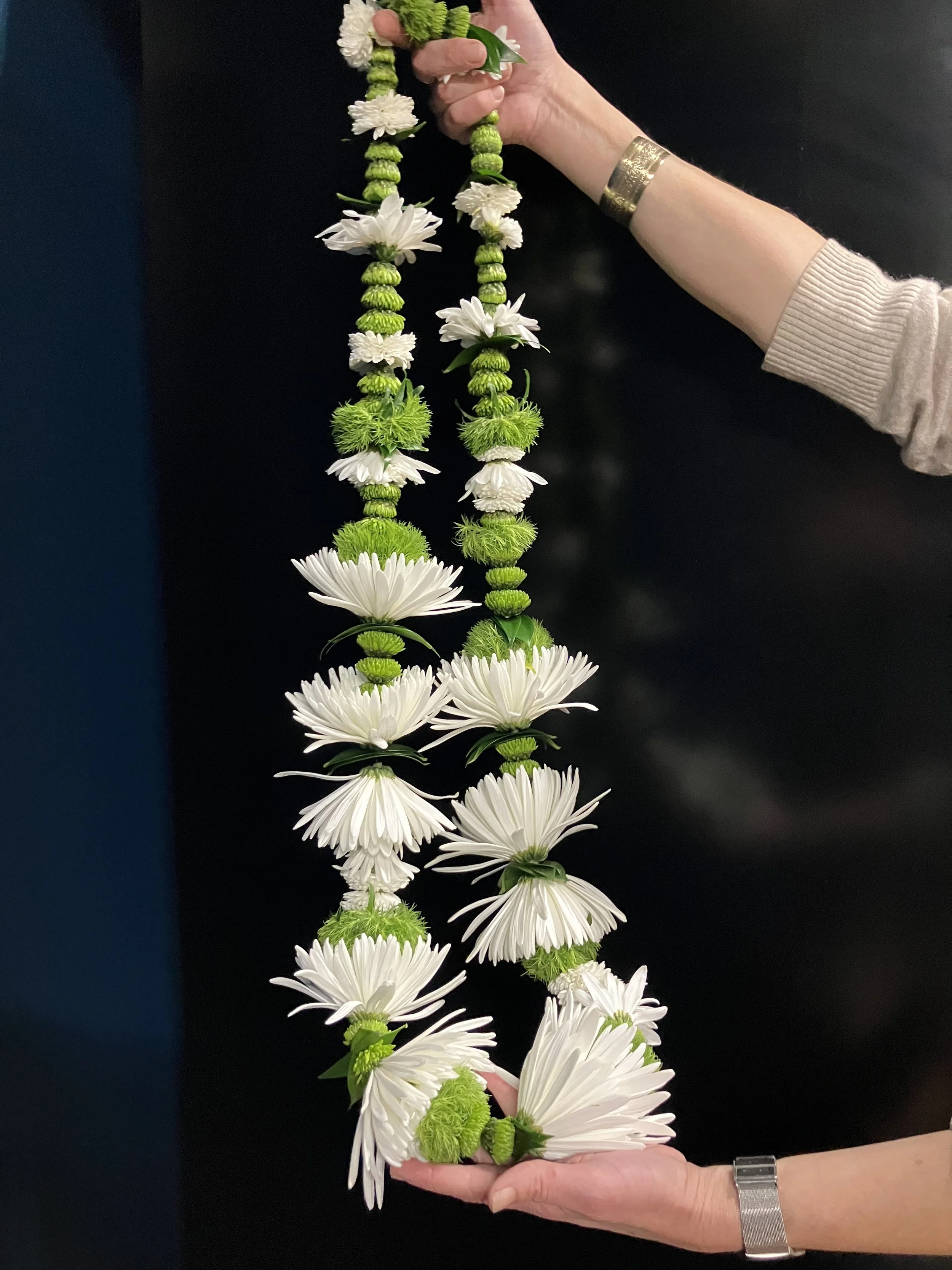 Custom garland strung from green and white blooms