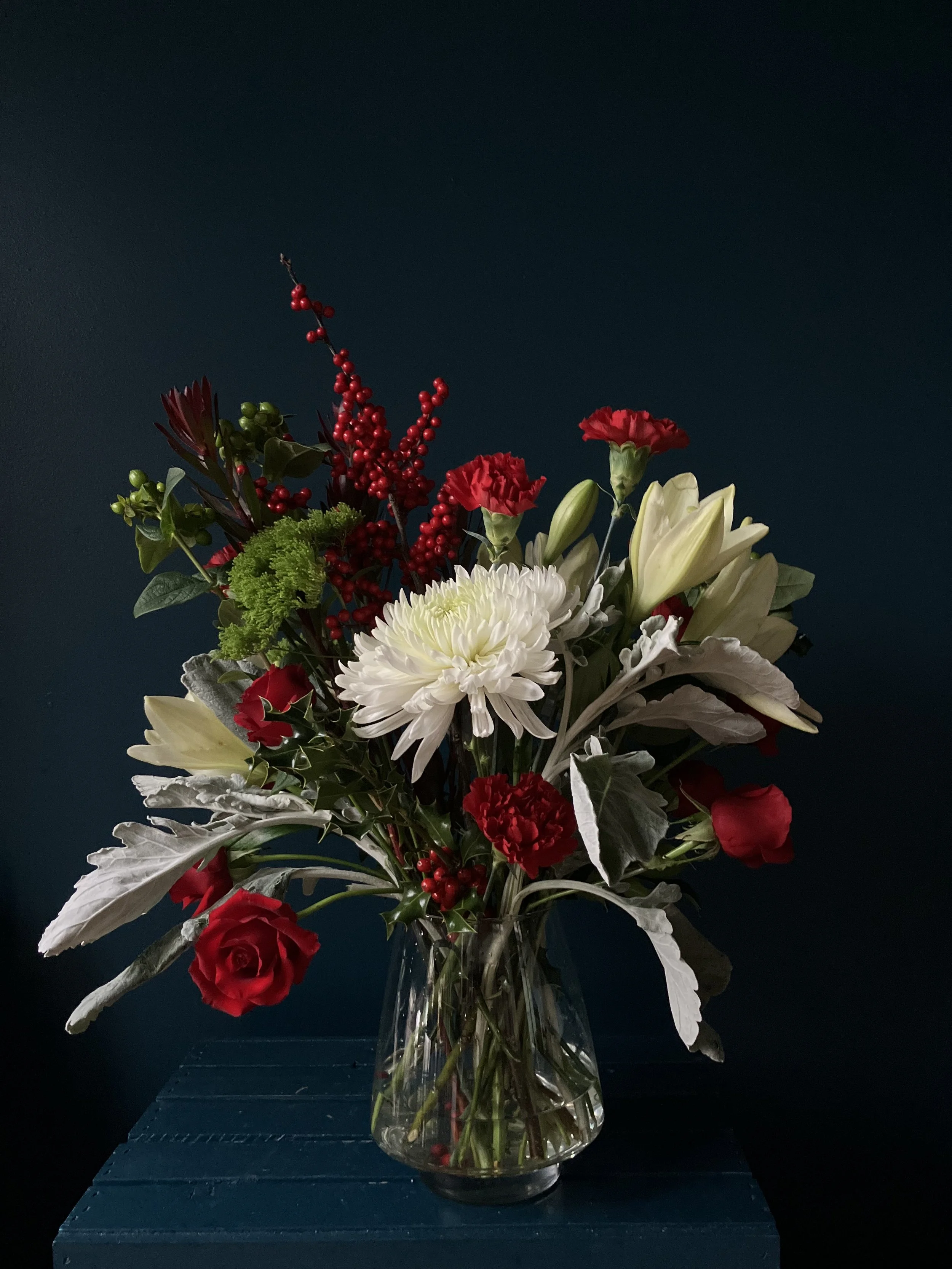 A view of our Christmas floral piece from the other side showing different angles of mums, roses and lilies