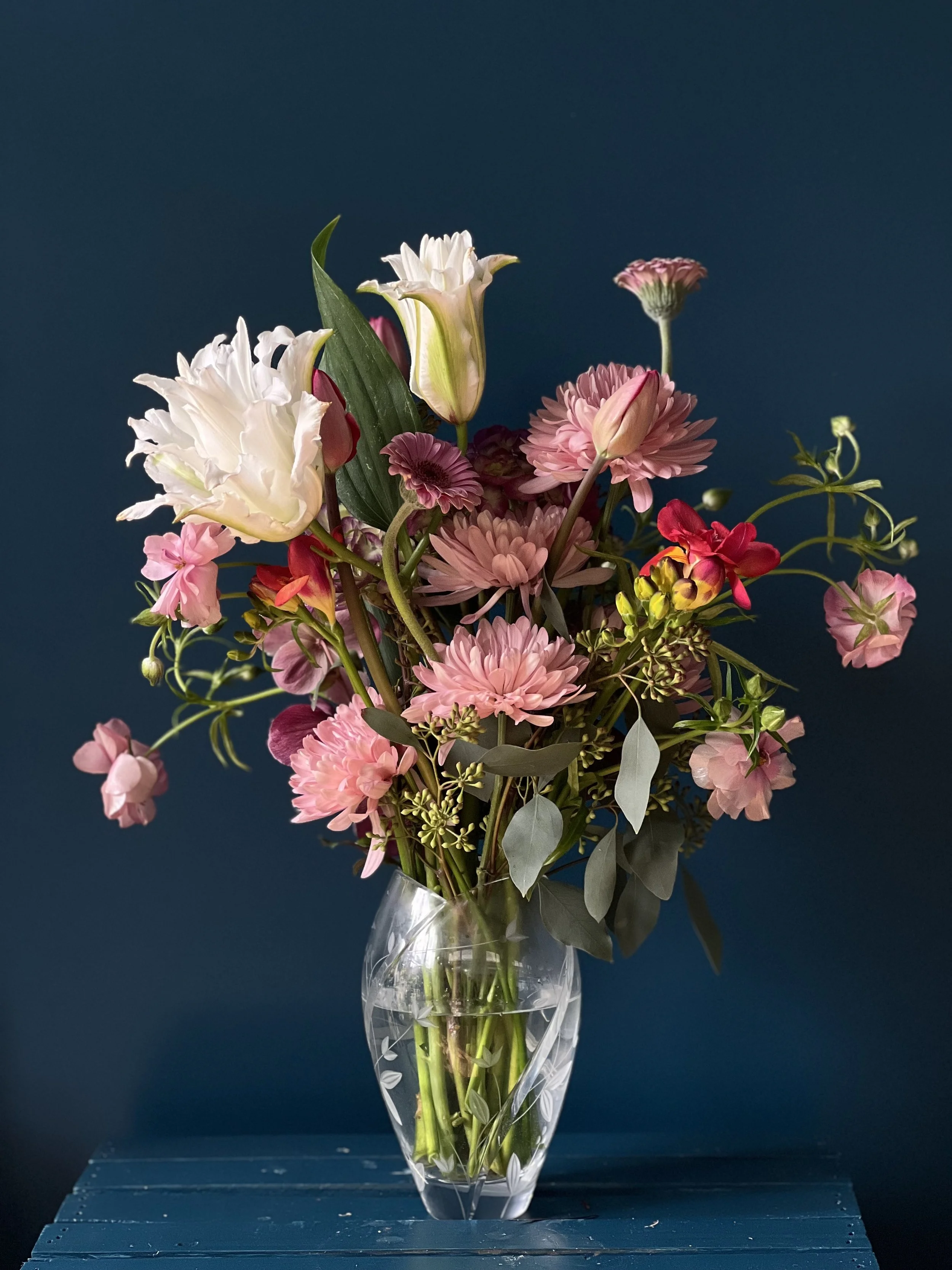 Flowing outward but dense centered, blush-toned late spring bouquet that leans toward summer flowers, arranged with movement