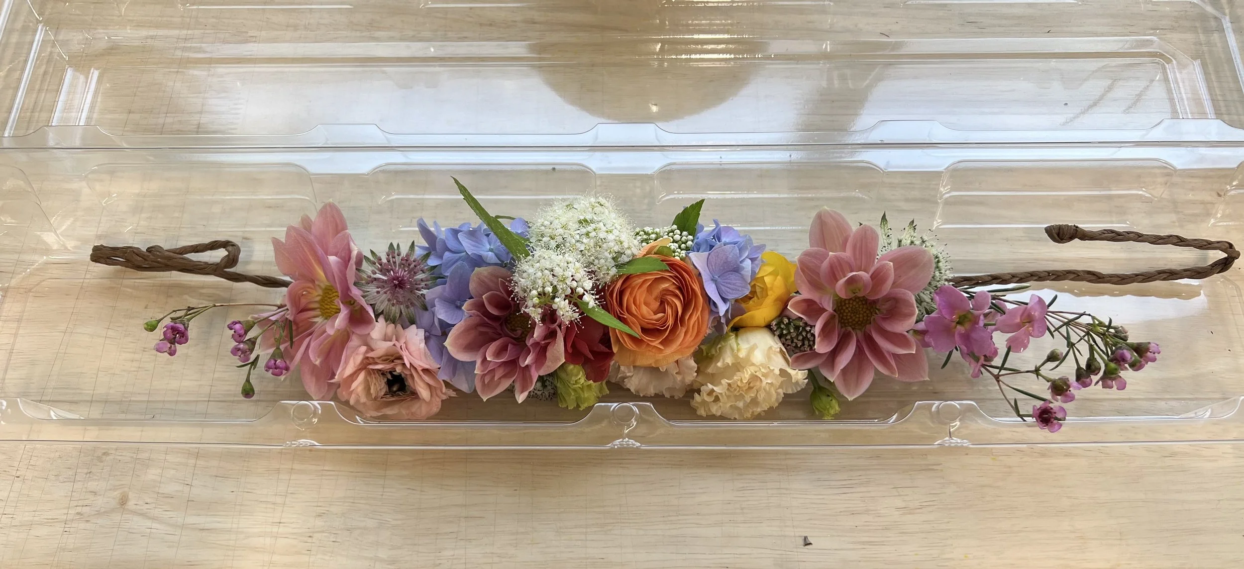 Semi-circular floral crown with dahlias in container, designed as a floral wearable in Portland Oregon flower shop