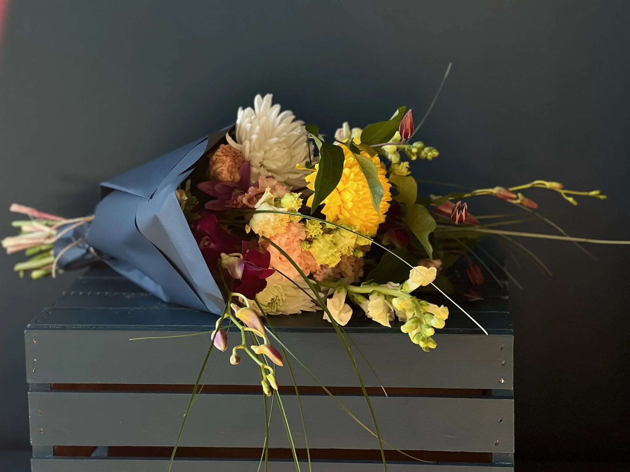 Elevated delivery bouquet from north Portland florist, wrapped and achieved with orchid, lisianthus, mums and snapdragons