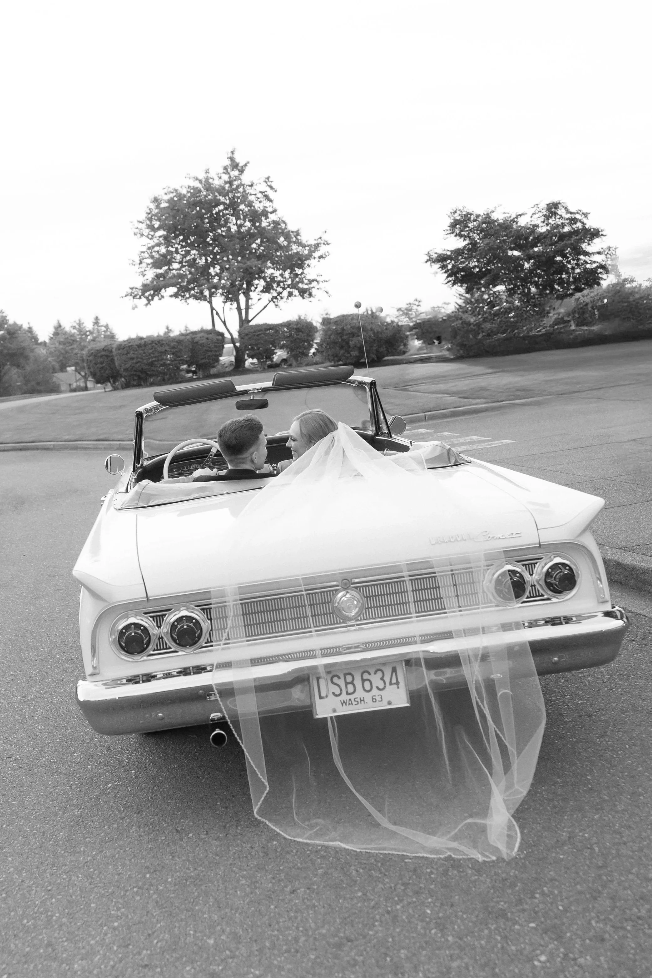 bride and groom in classic car at their luxury wedding in the pacific northwest