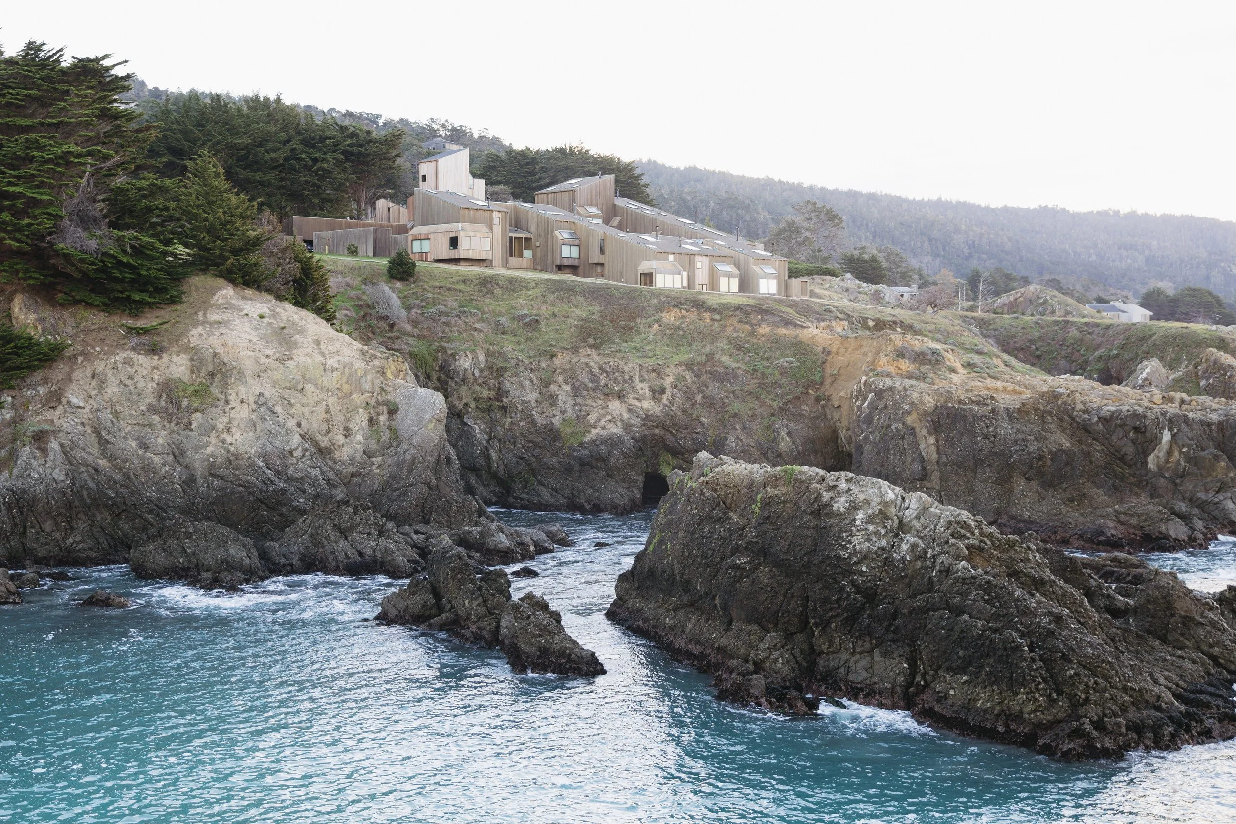 sea ranch lodge perched above the pacific ocean with expansive coastal views