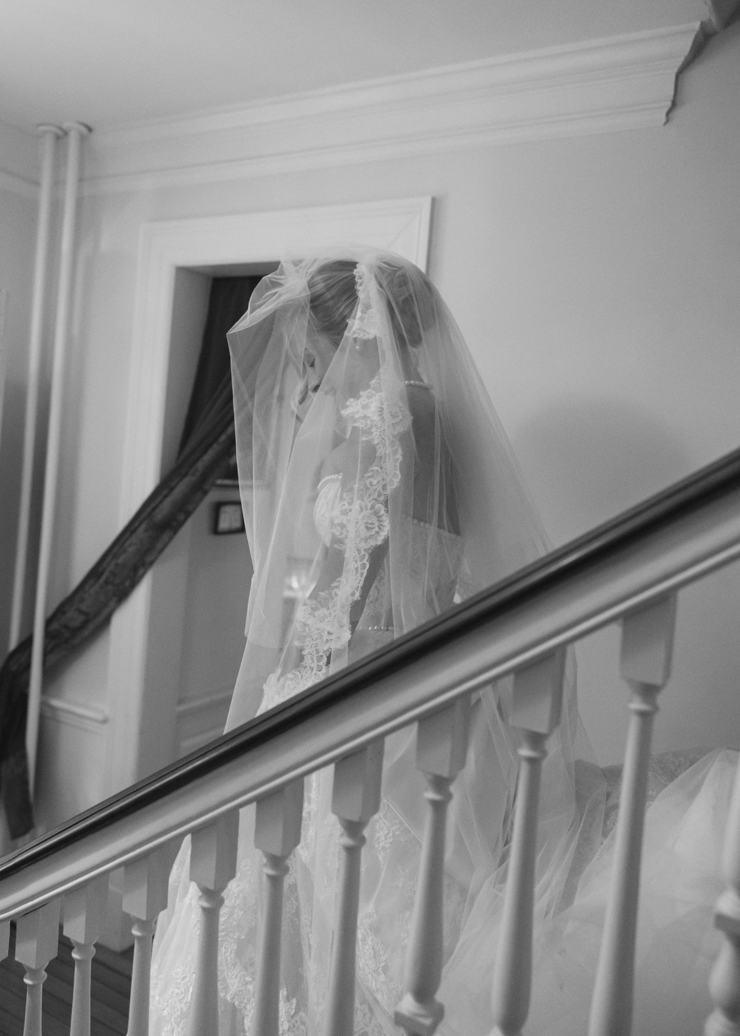 editorial bridal portrait on staircase with lace wedding dress