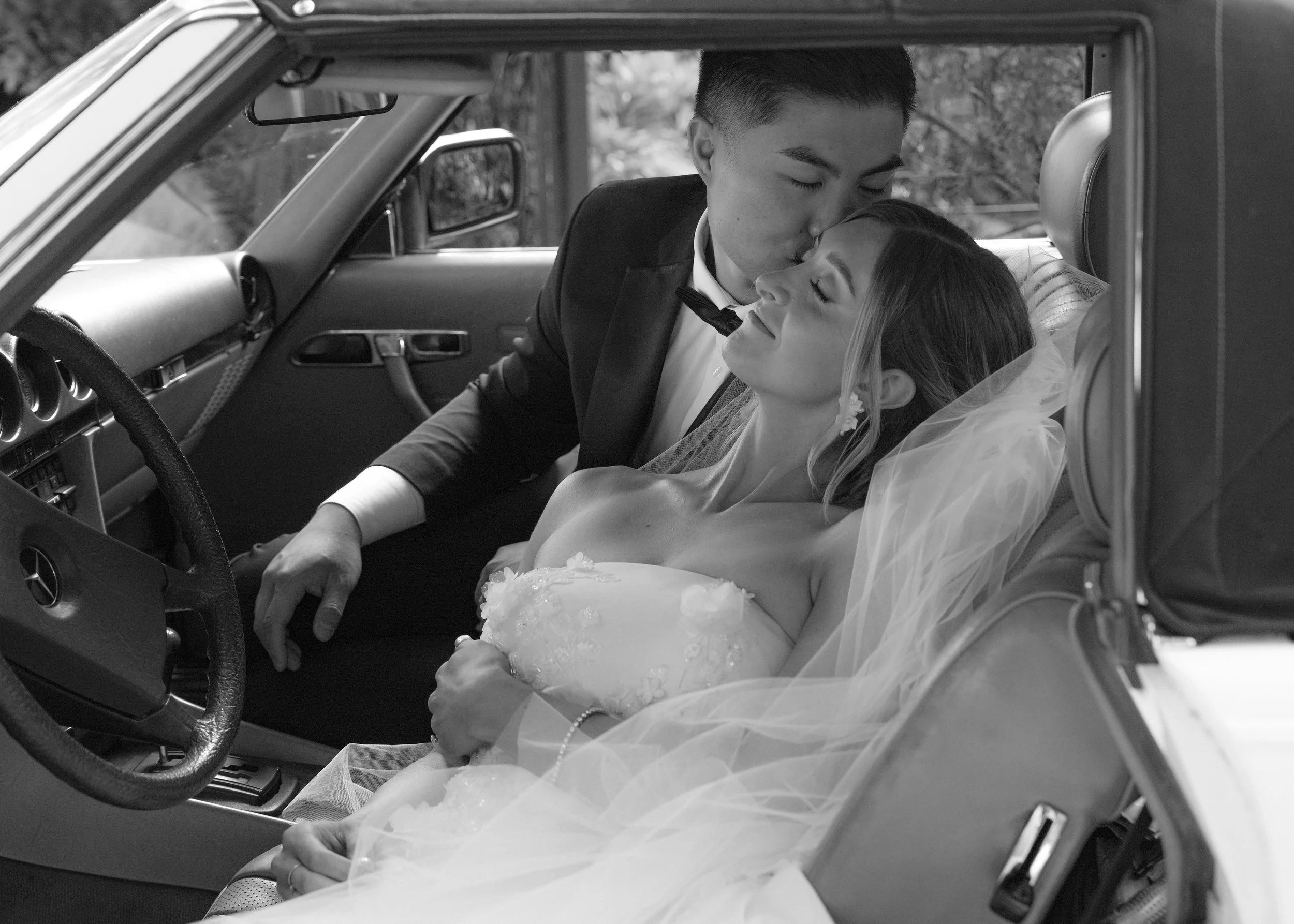 bride and groom portraits in classic car
