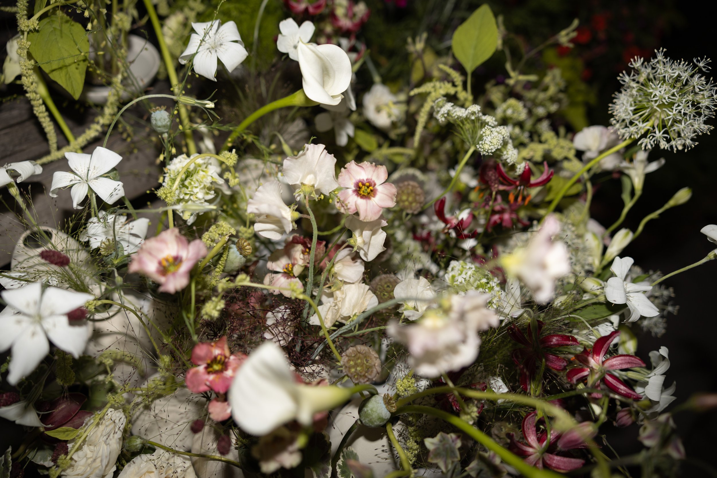burgundy wild flowers in wedding floral arrangement