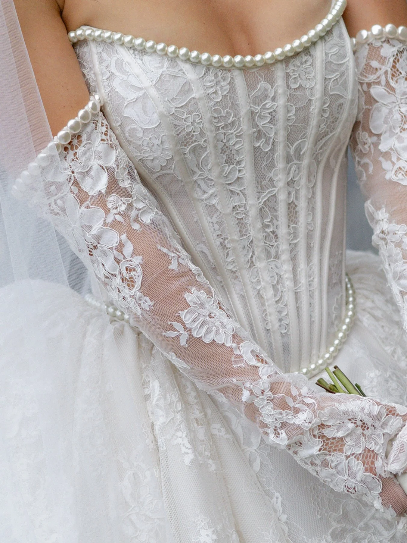 high-fashion wedding dress with lace and pearl corset and sleeves