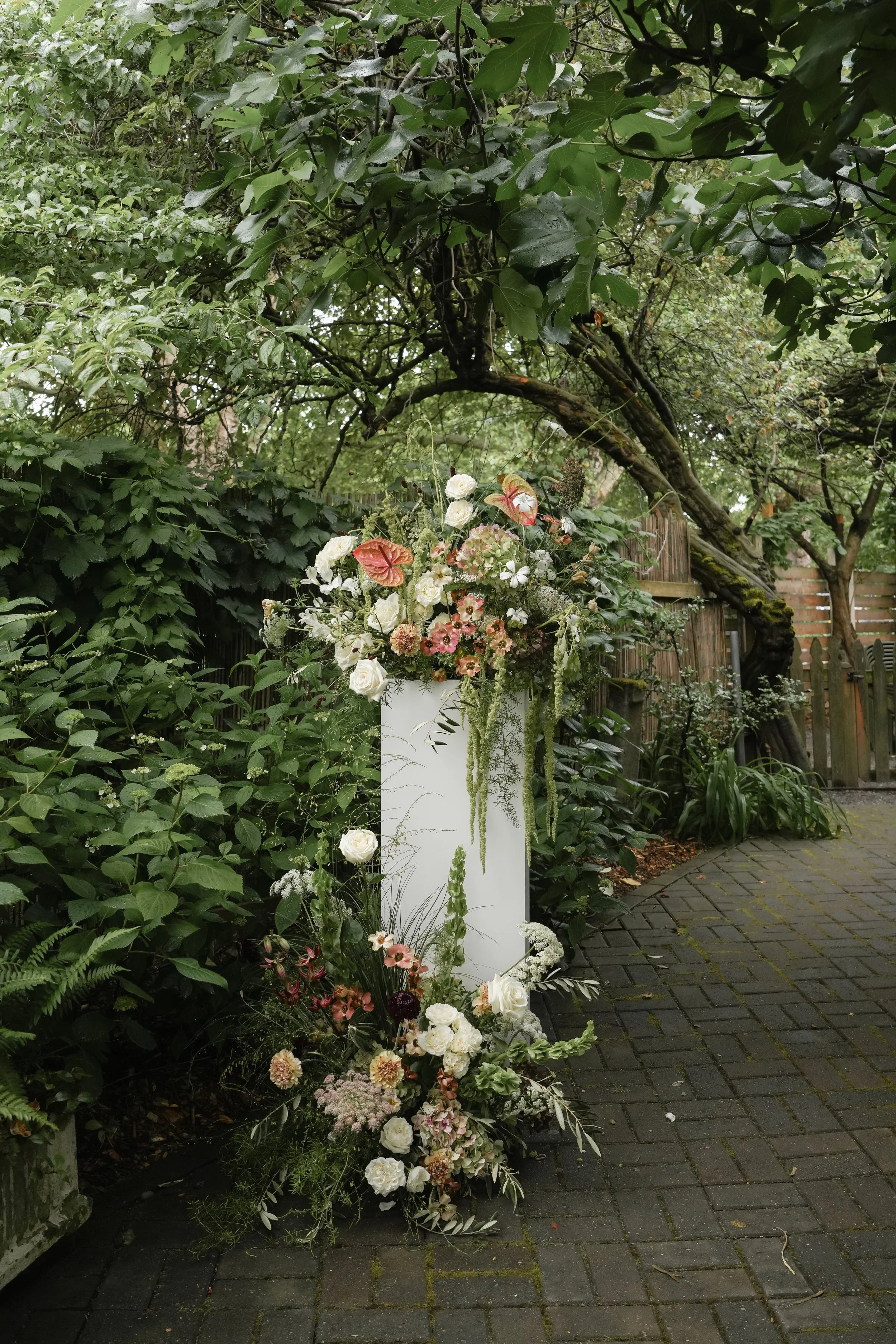 wedding ceremony floral arrangement and design on the corson building patio