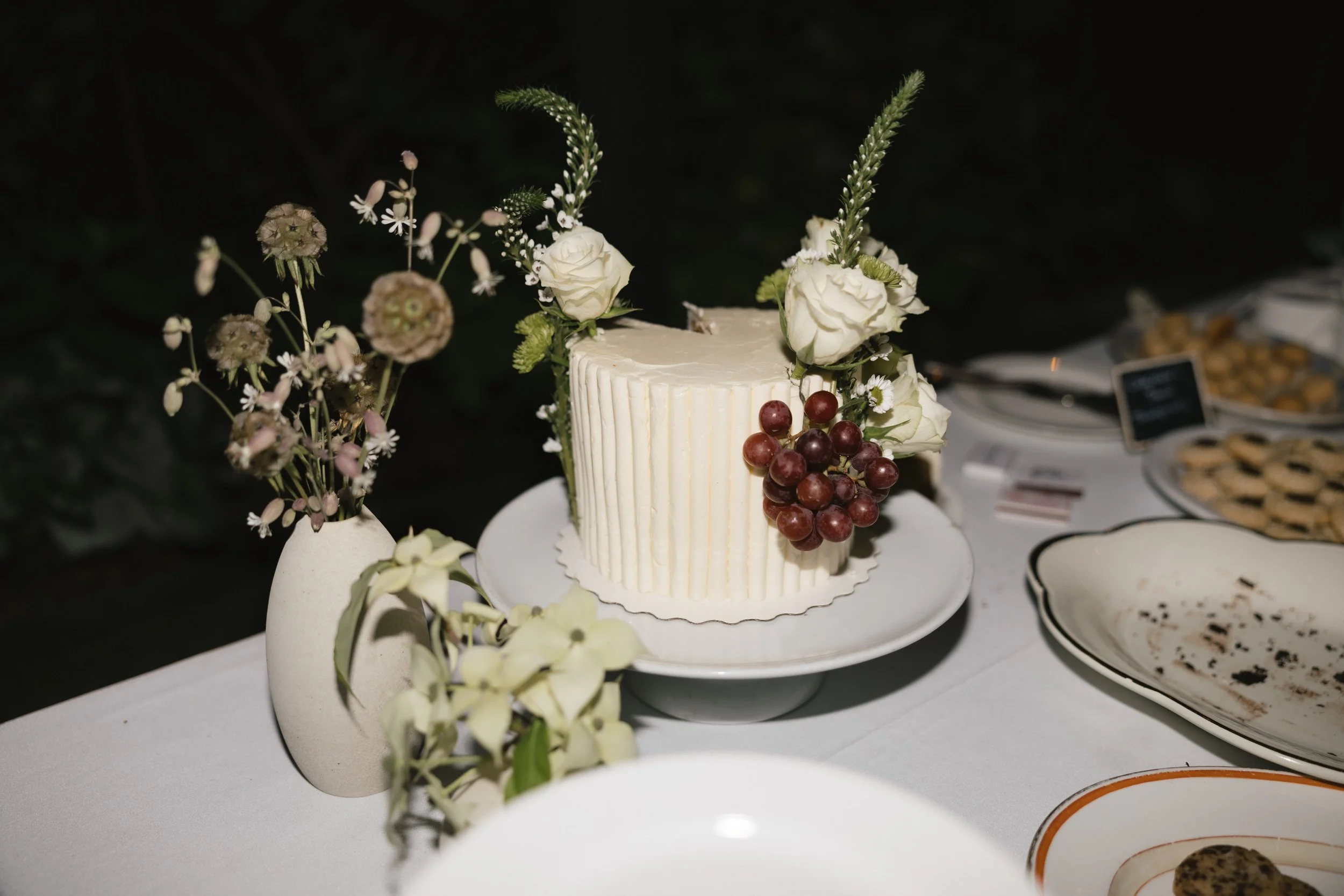 modern wedding cake with florals and fruit