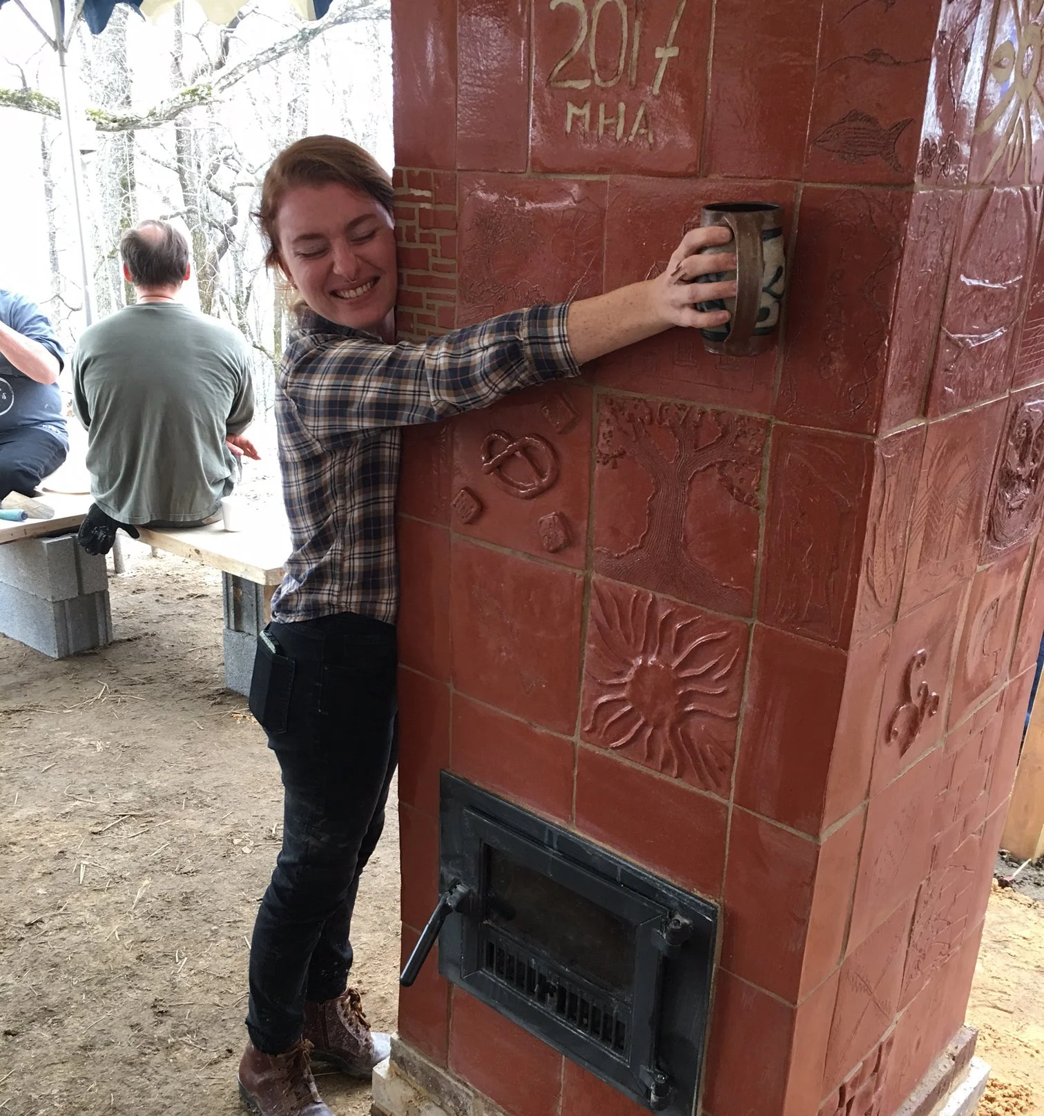 Girl hugging warm red fireplace