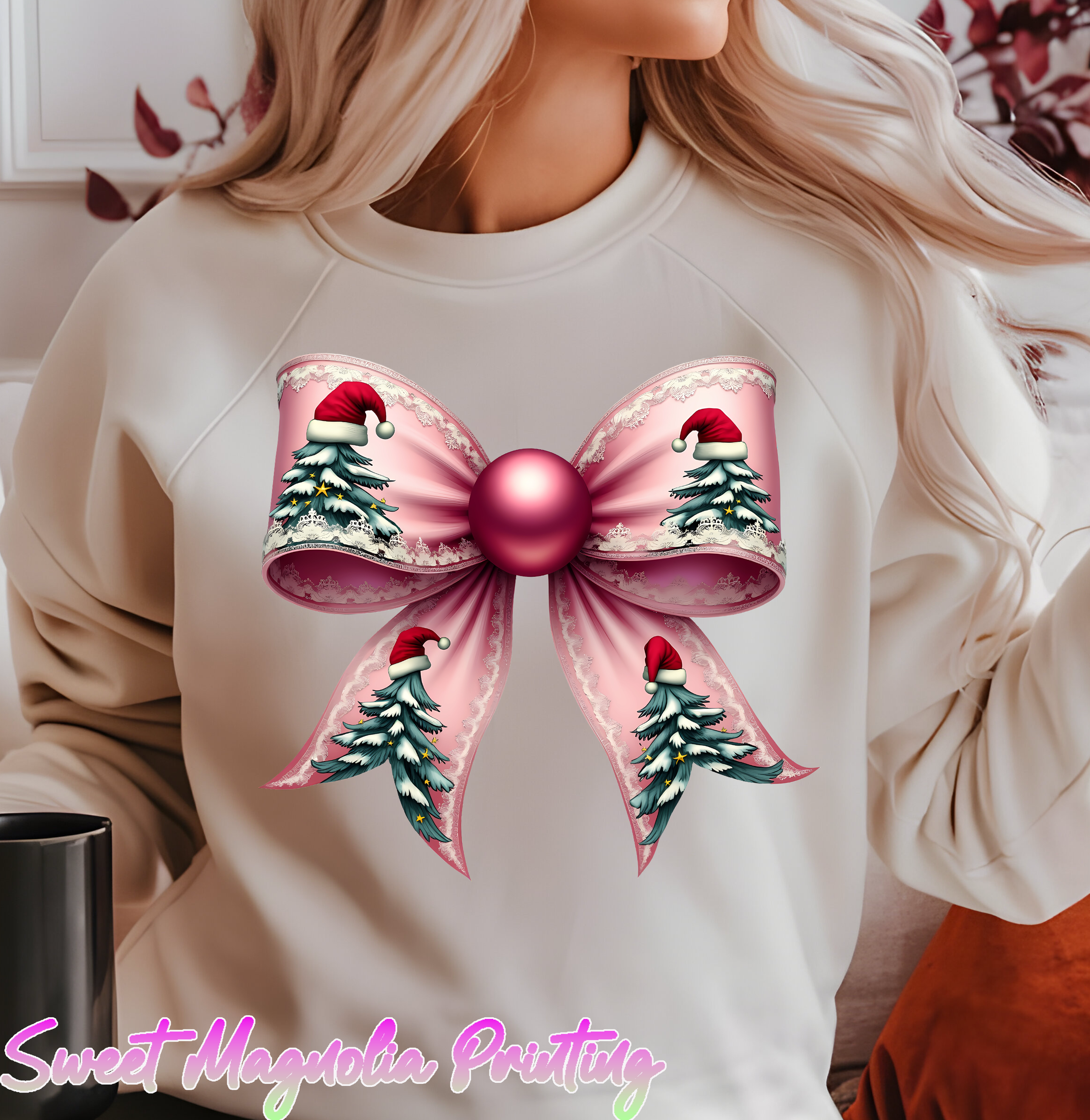 A festive pink ribbon bow adorned with Christmas trees and red Santa hats, featuring a shiny central ornament | Christmas Transfer | Sweet Magnolia Printing