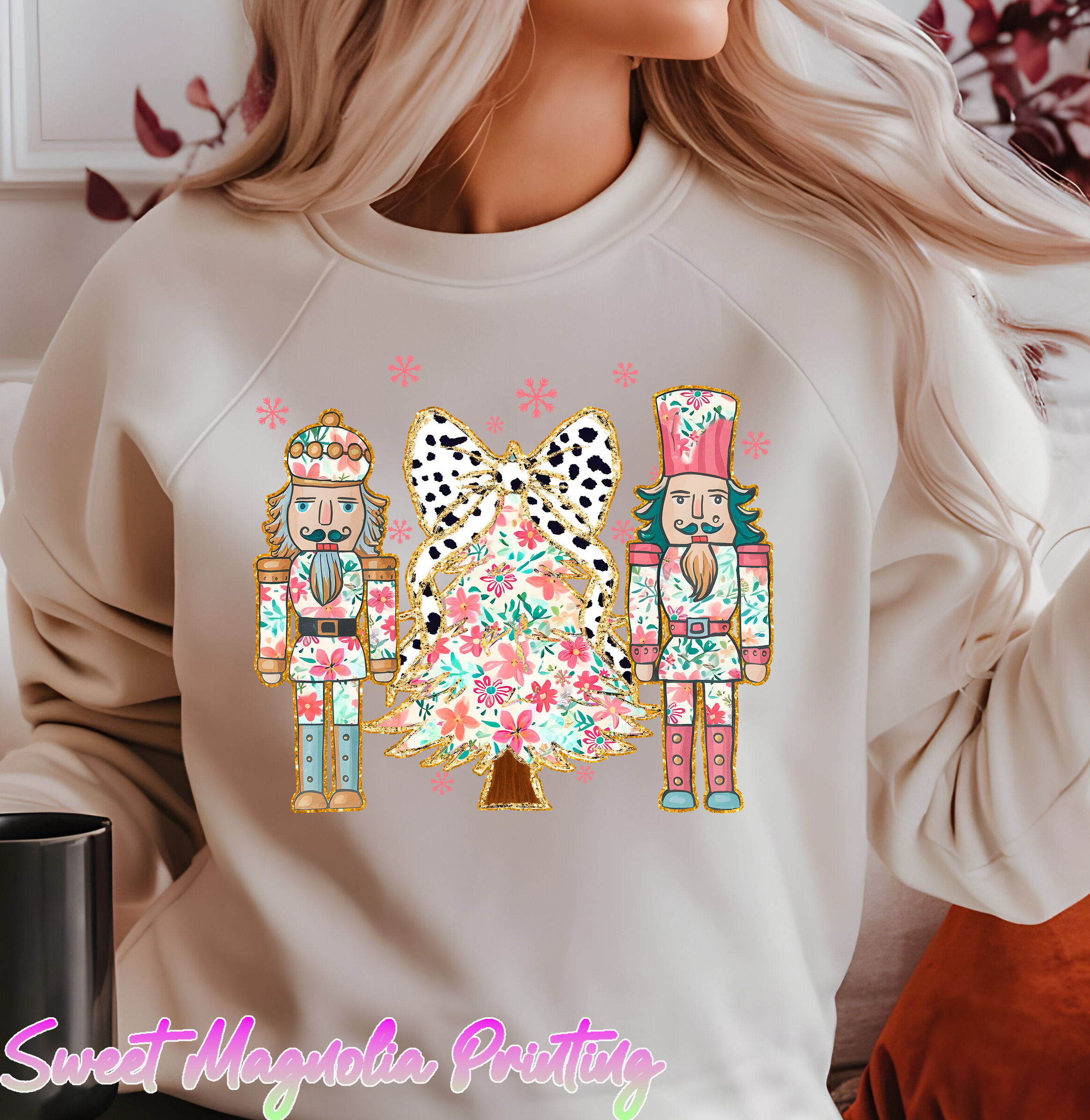 Two colorful nutcracker soldiers flank a floral Christmas tree adorned with a black and white bow, surrounded by pink flowers | DTF Transfer | Sweet Magnolia Printing