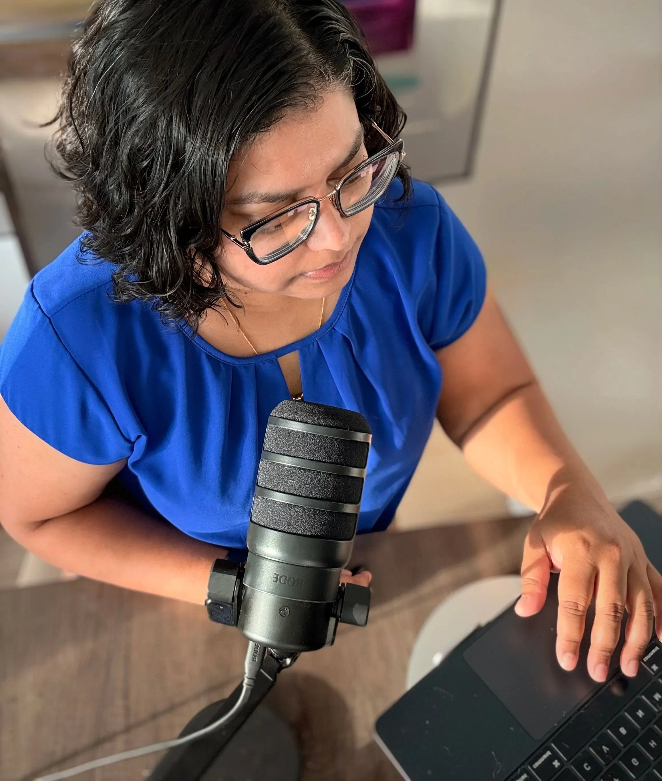 Dr. Z recording Unseen but Not Untold Podcast at her desk