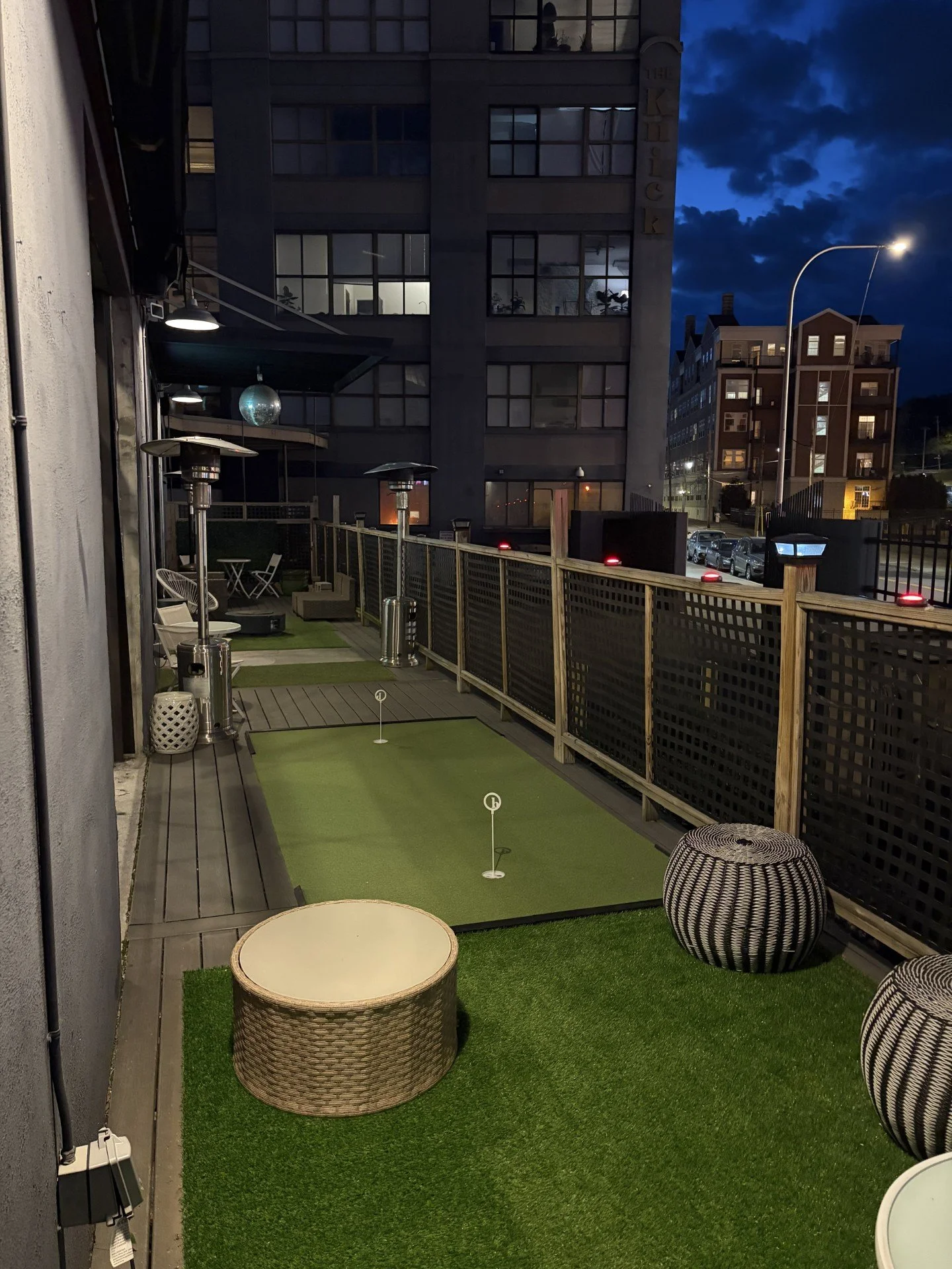 Outdoor patio with putting green at night