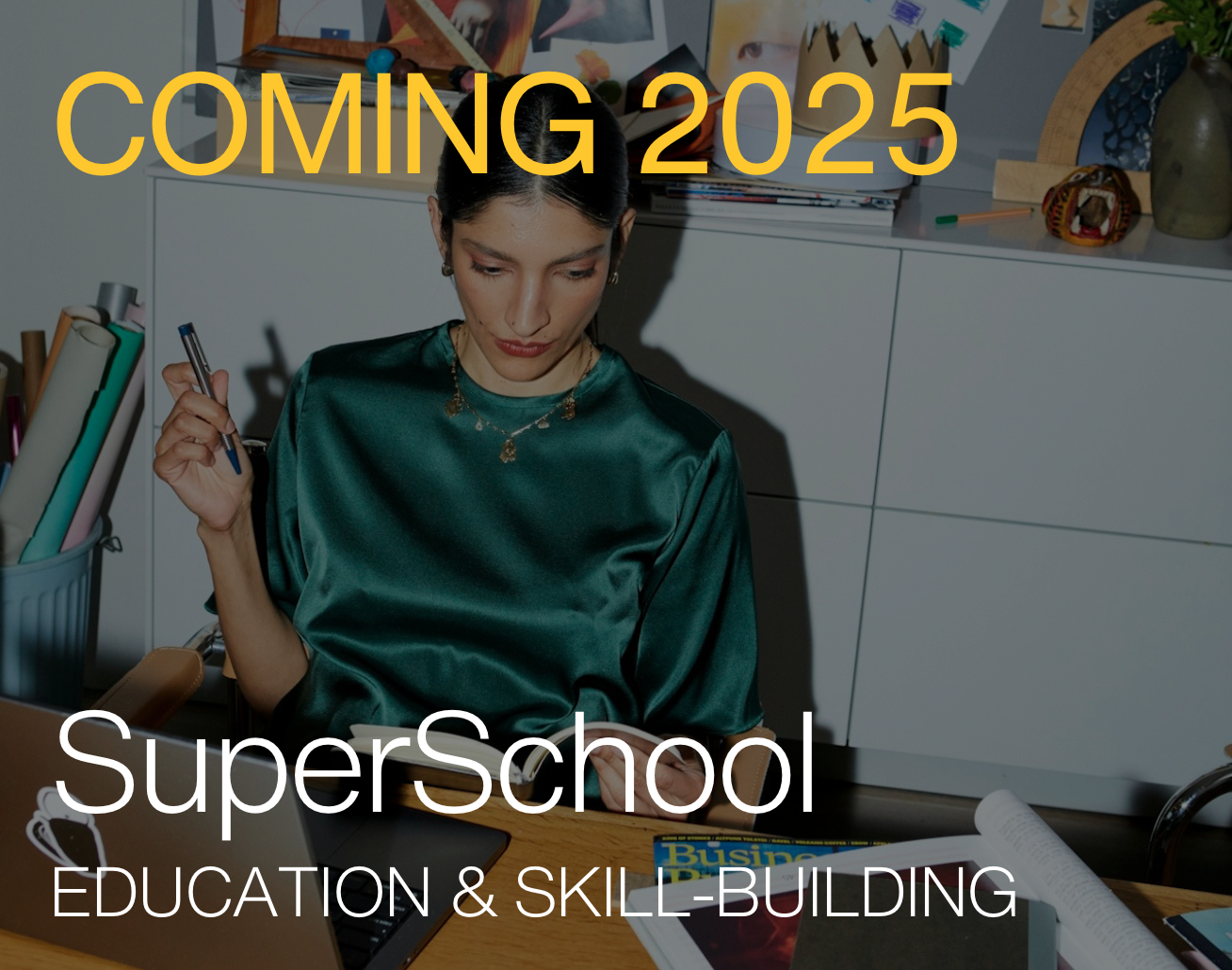 Woman in green silk blouse working at a desk surrounded by stationery and documents. Text overlay reads 'Coming 2025 SuperSchool Education & Skill-Building.'