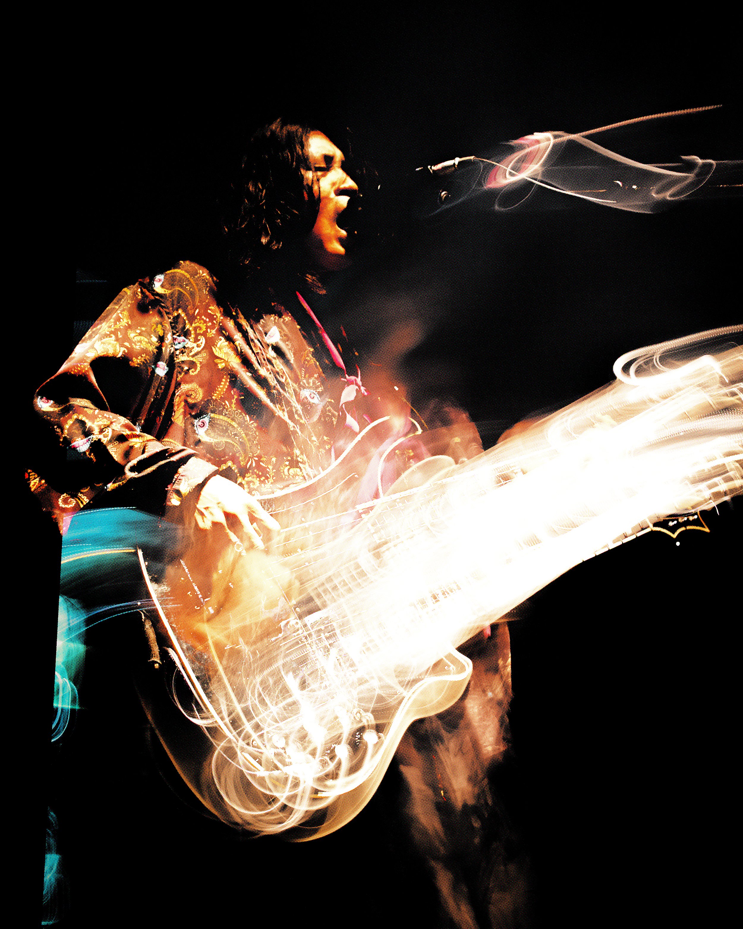 A person with curly hair, wearing a patterned shirt, passionately singing while playing an electric guitar on stage with abstract light effects.