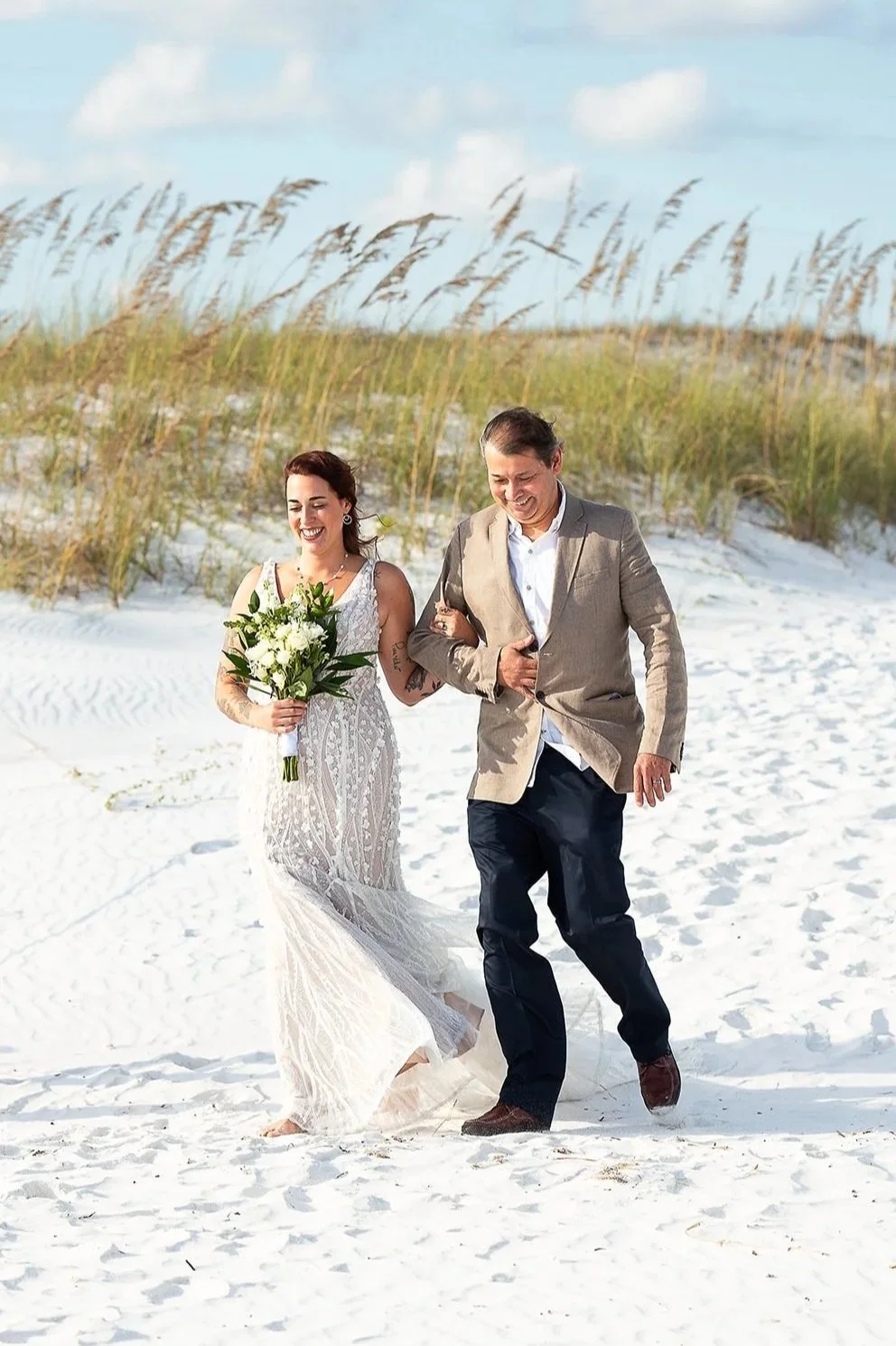 Couple celebrating their anniversary with a vow renewal surrounded by family on Destin Beach