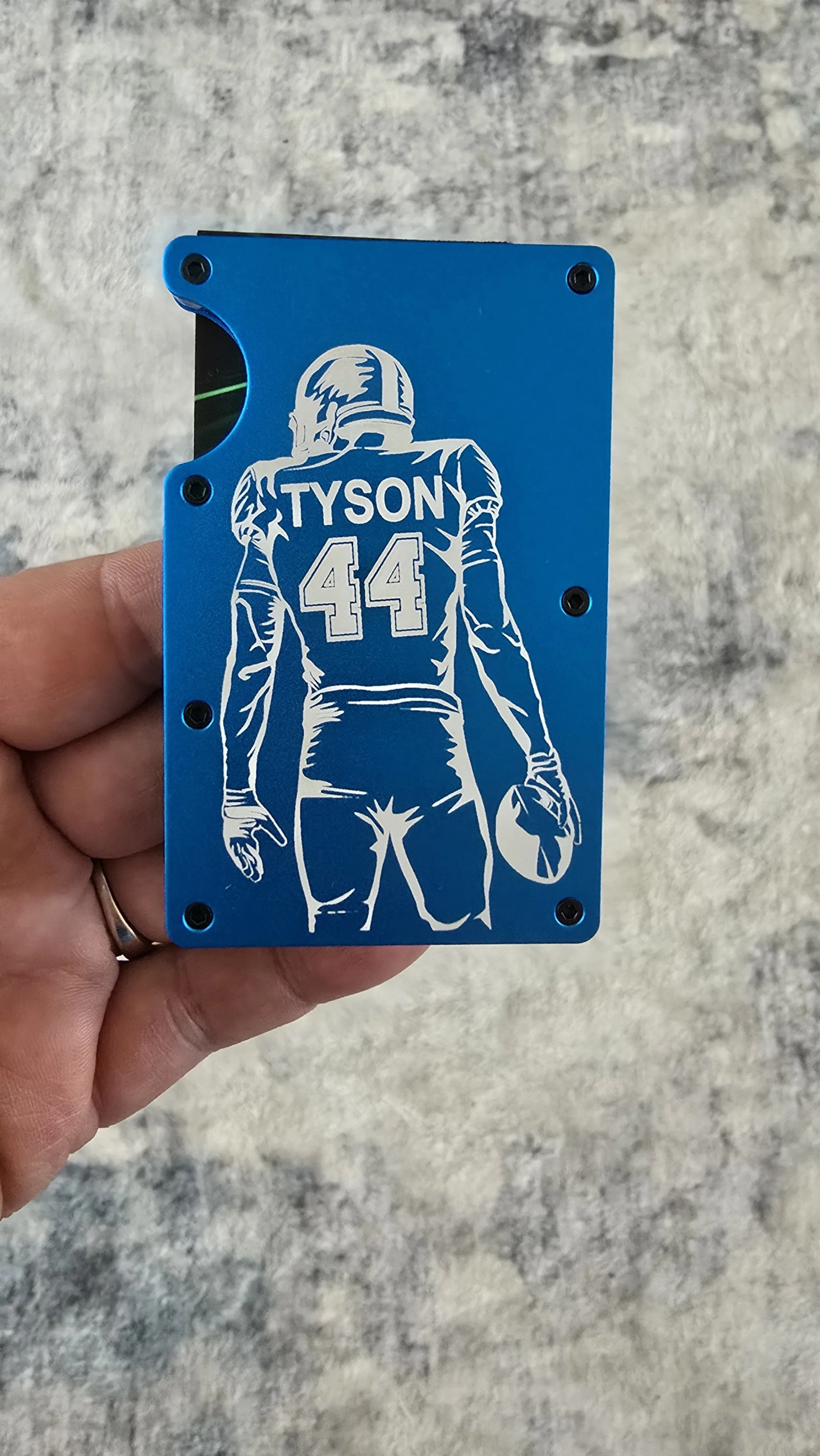 Metal Wallet with Football Player holding a football with his name and jersey number laser engraved on the wallet.