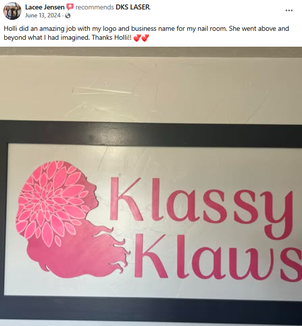 Sign with a pink silhouette of a girl with floral hair and the words 'Klassy Klaws' in pink.